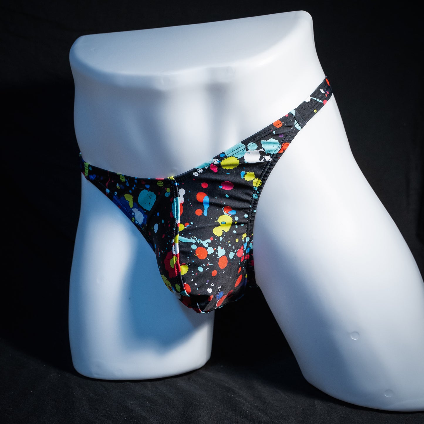 Men's paint splatter thong underwear, classic cut, front view.