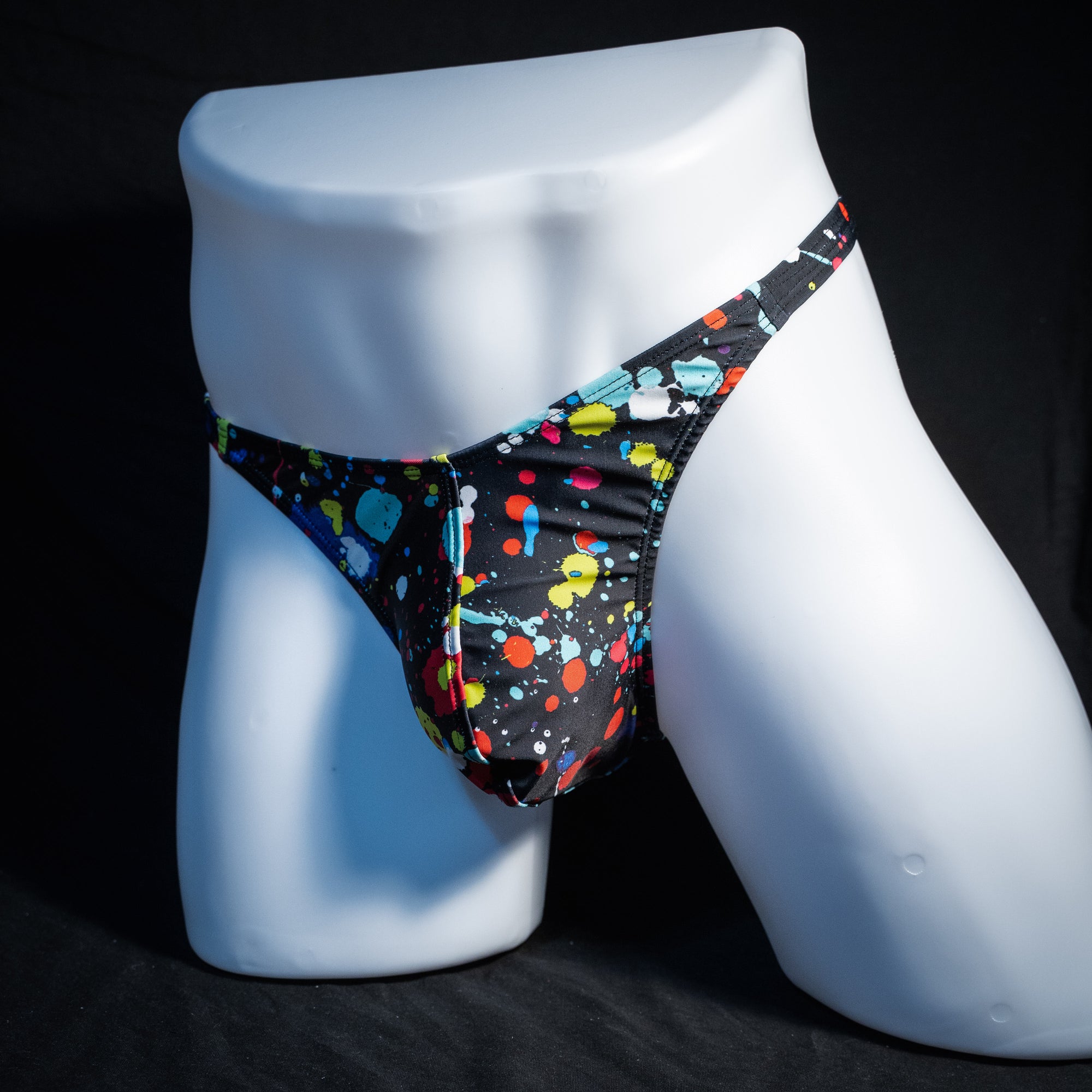 Men's paint splatter thong underwear, classic cut, front view.