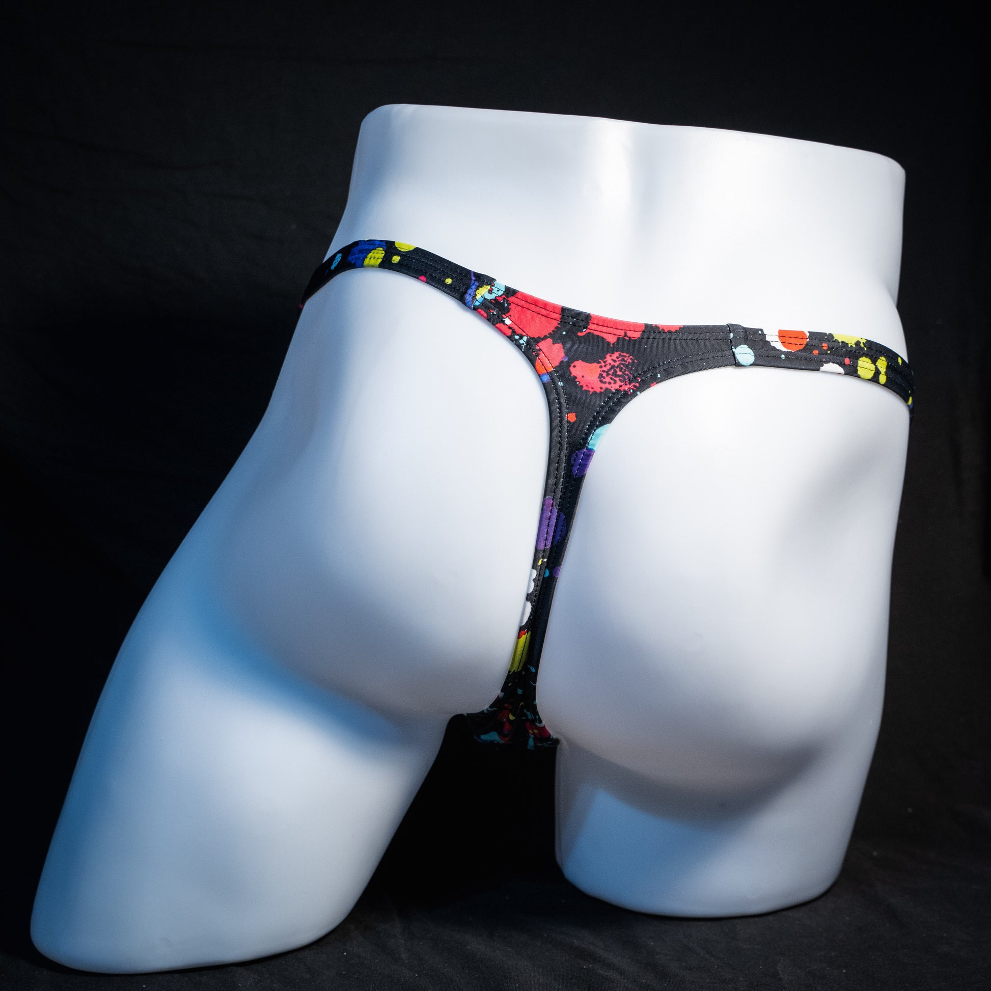 Men's paint splatter thong underwear, classic cut, rear view.