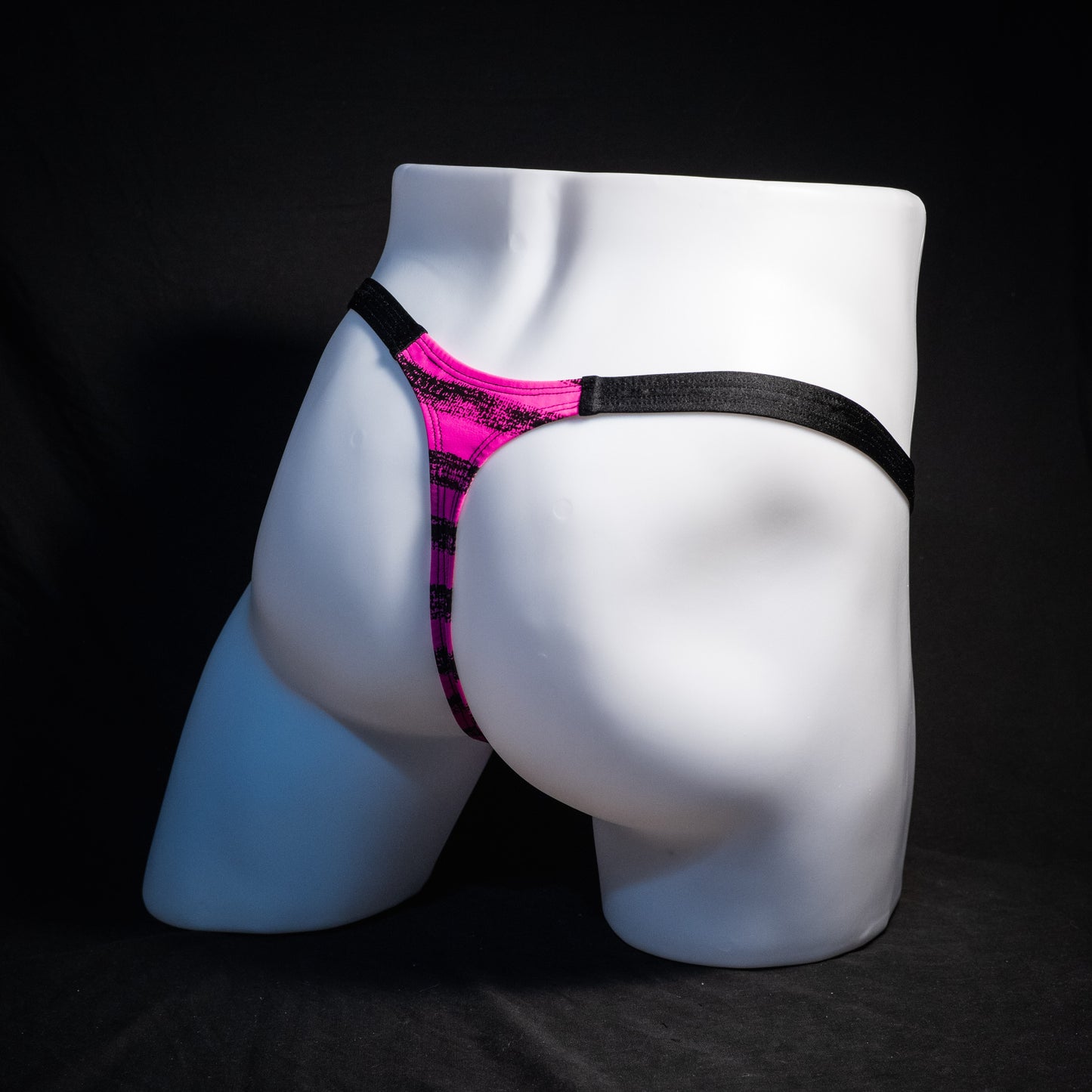 Men's pink and black striped thong underwear, classic cut, rear view.