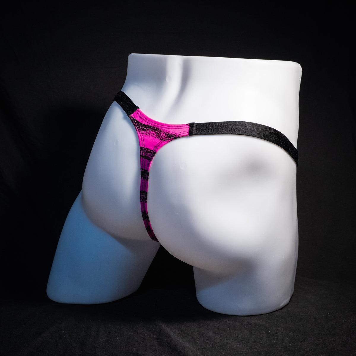 Men's pink and black striped thong underwear, classic cut, rear view.