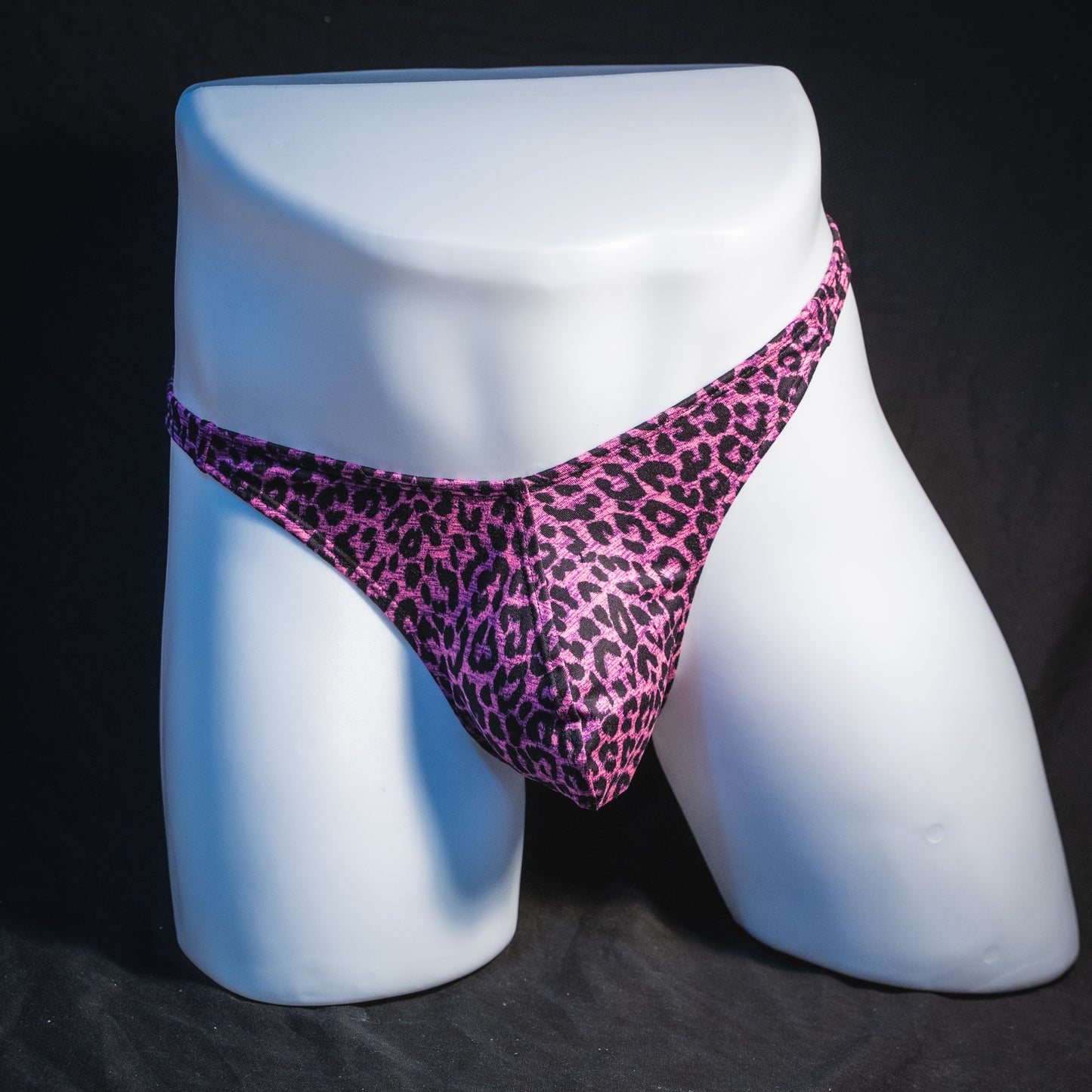 Men's pink leopard thong underwear, classic cut, full front view.