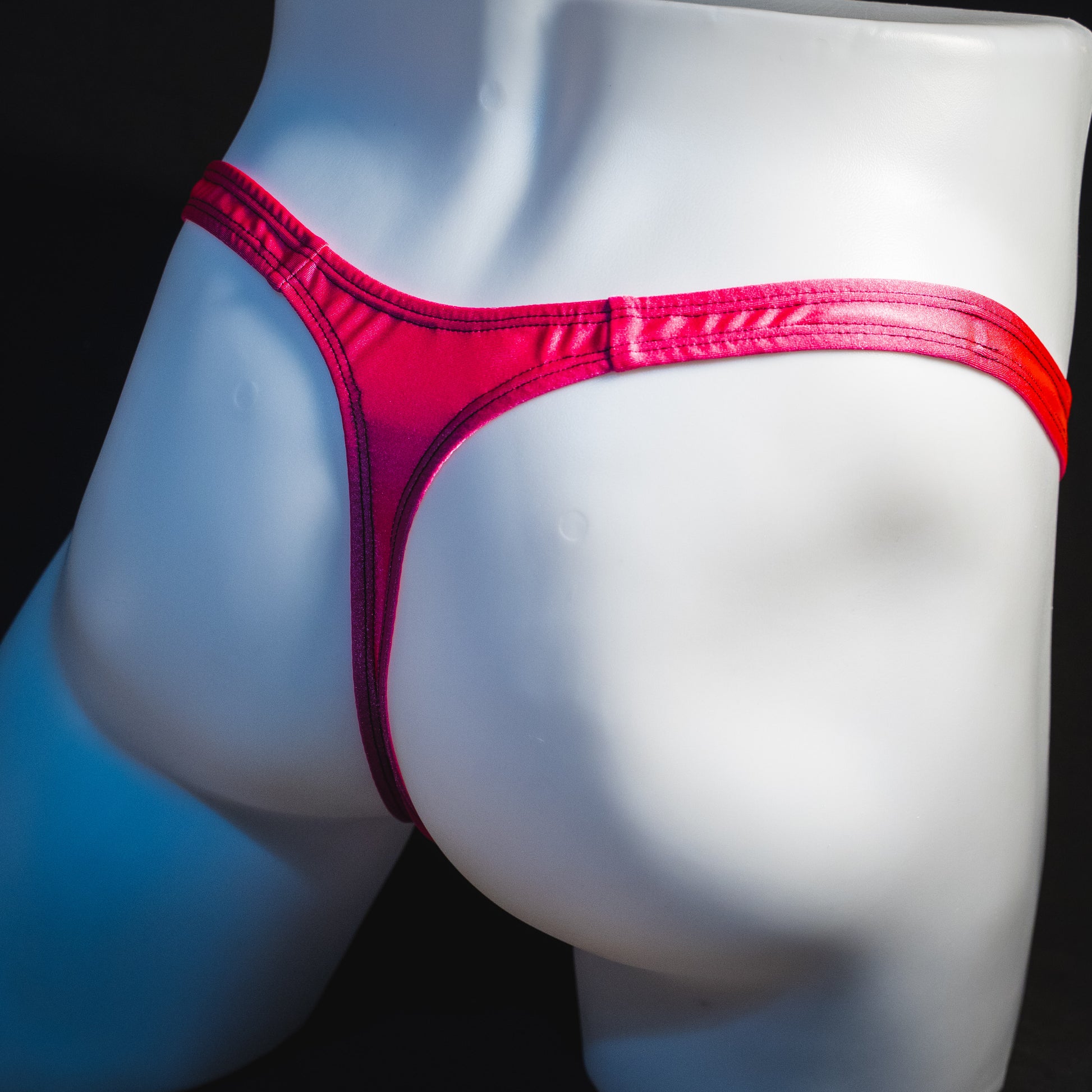 Men's pink leopard thong underwear, classic cut, rear angled view.