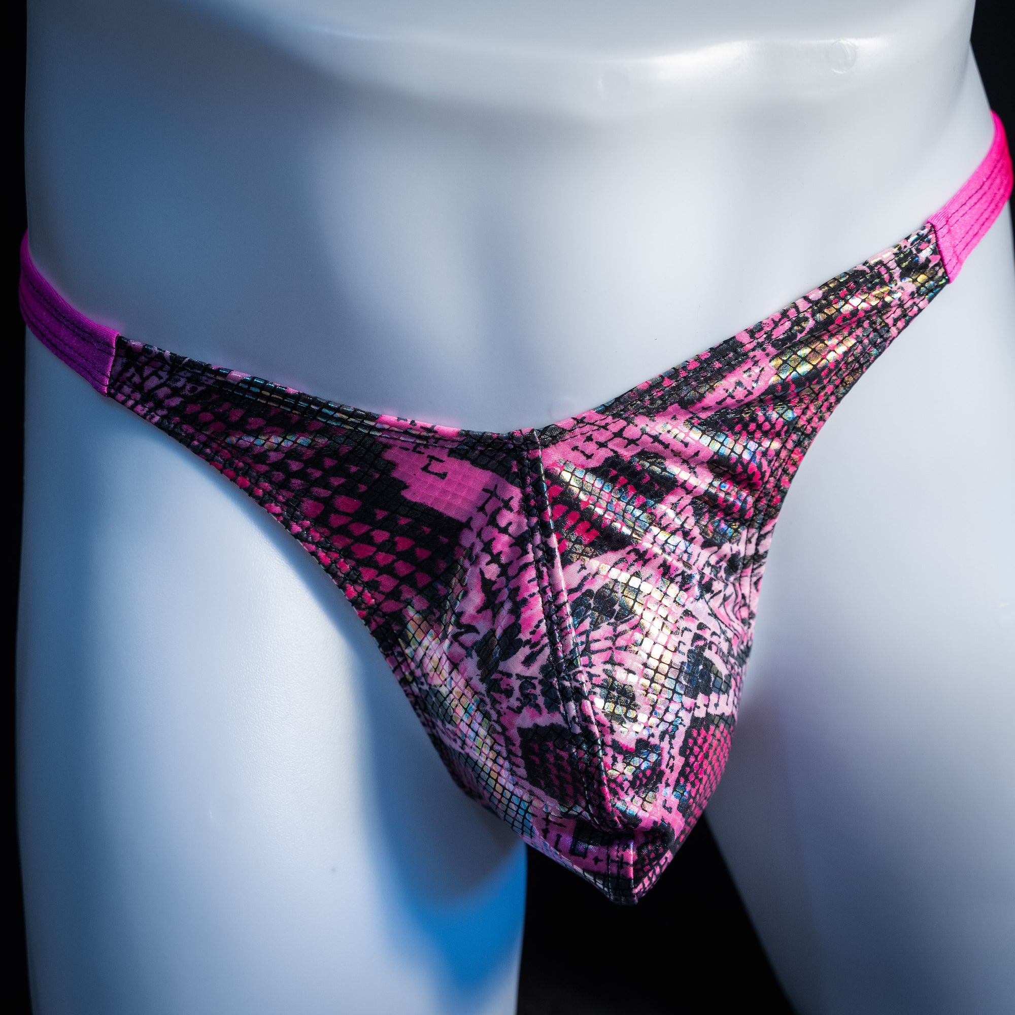 Men's pink metallic snakeskin thong underwear, classic cut, front view.