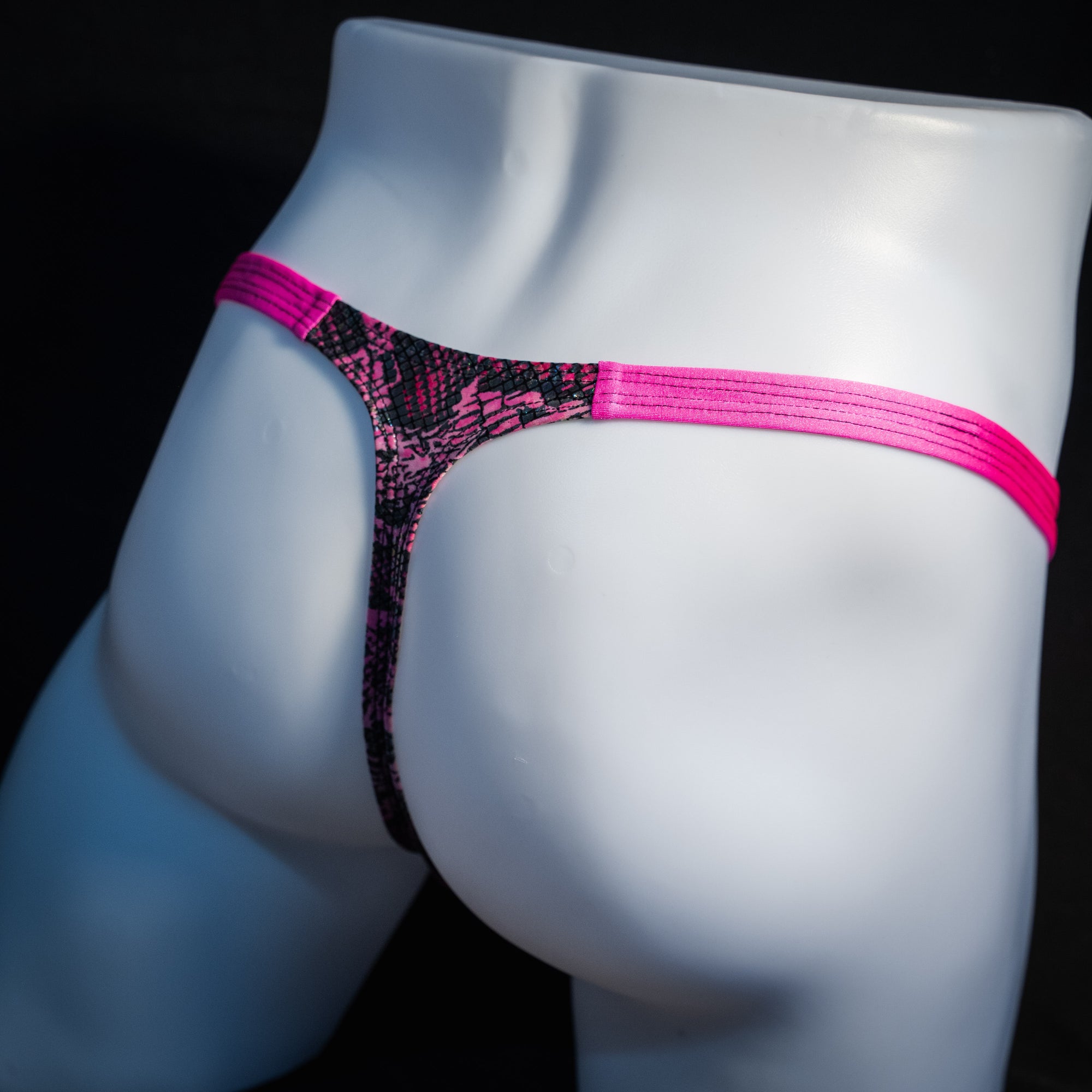 Men's pink metallic snakeskin thong underwear, classic cut, rear view.