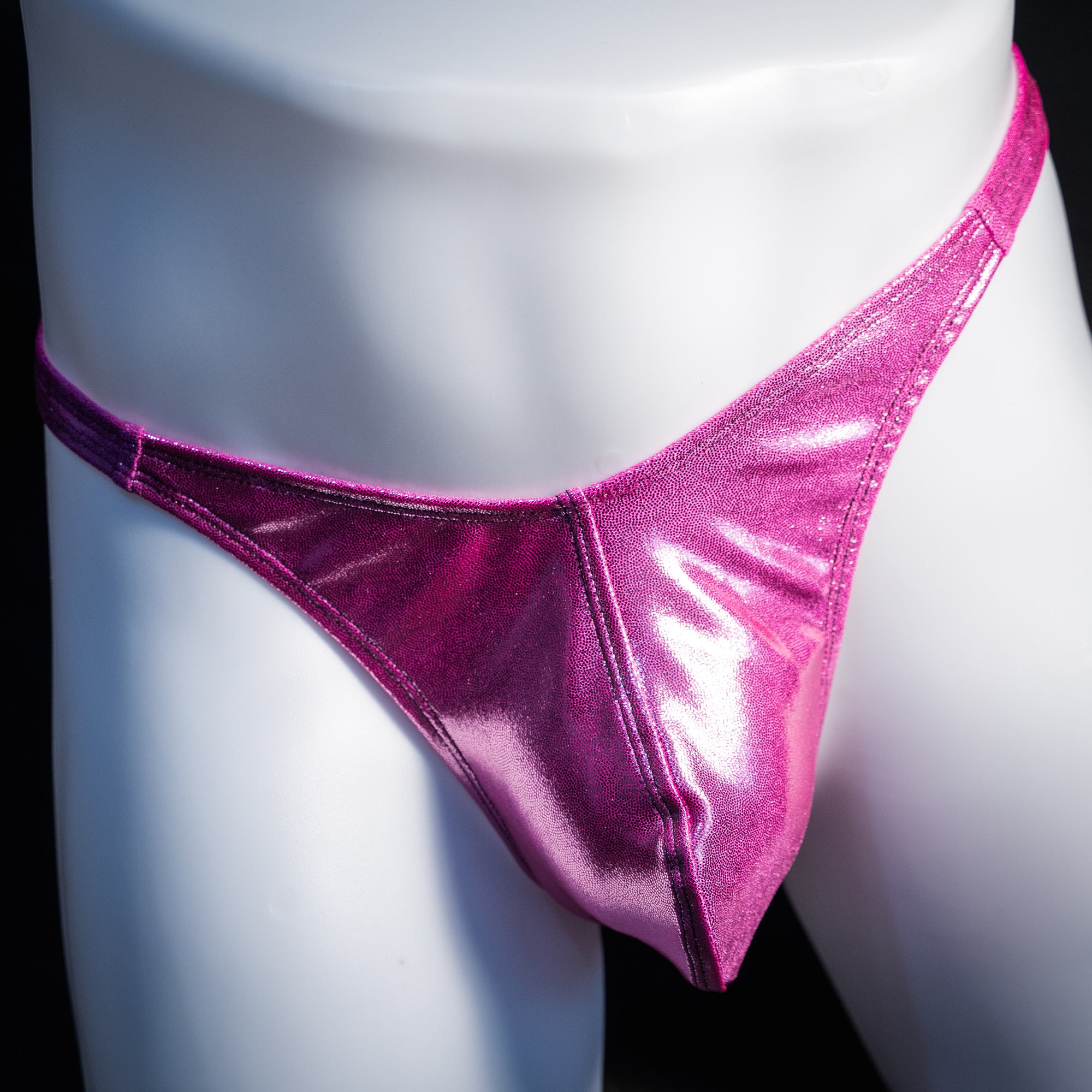 Men's pink metallic thong underwear, classic cut, front view.