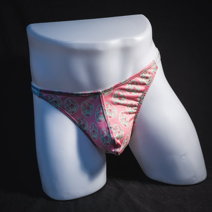 Men's pink painted easter eggs thong underwear, classic cut, full front view.
