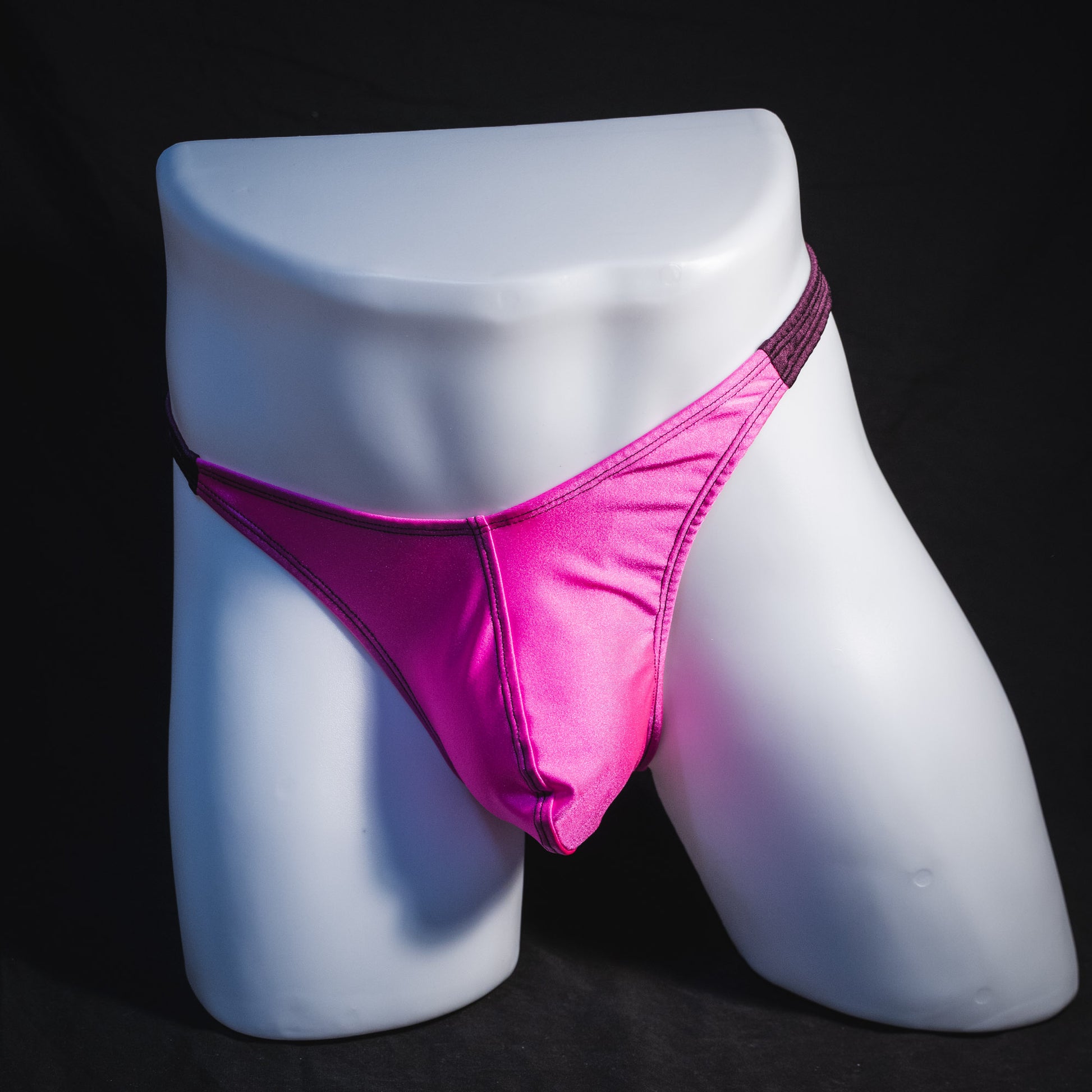 Men's pink and purple thong underwear, classic cut, full front view.