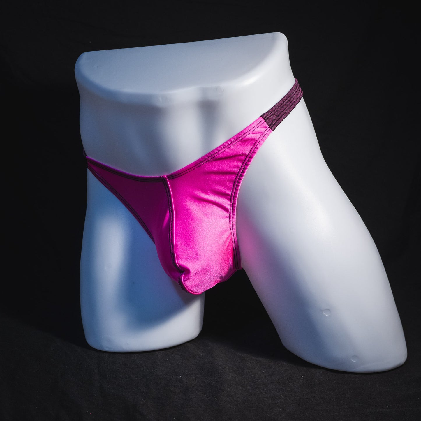 Men's pink and purple thong underwear, classic cut, full front angled view.