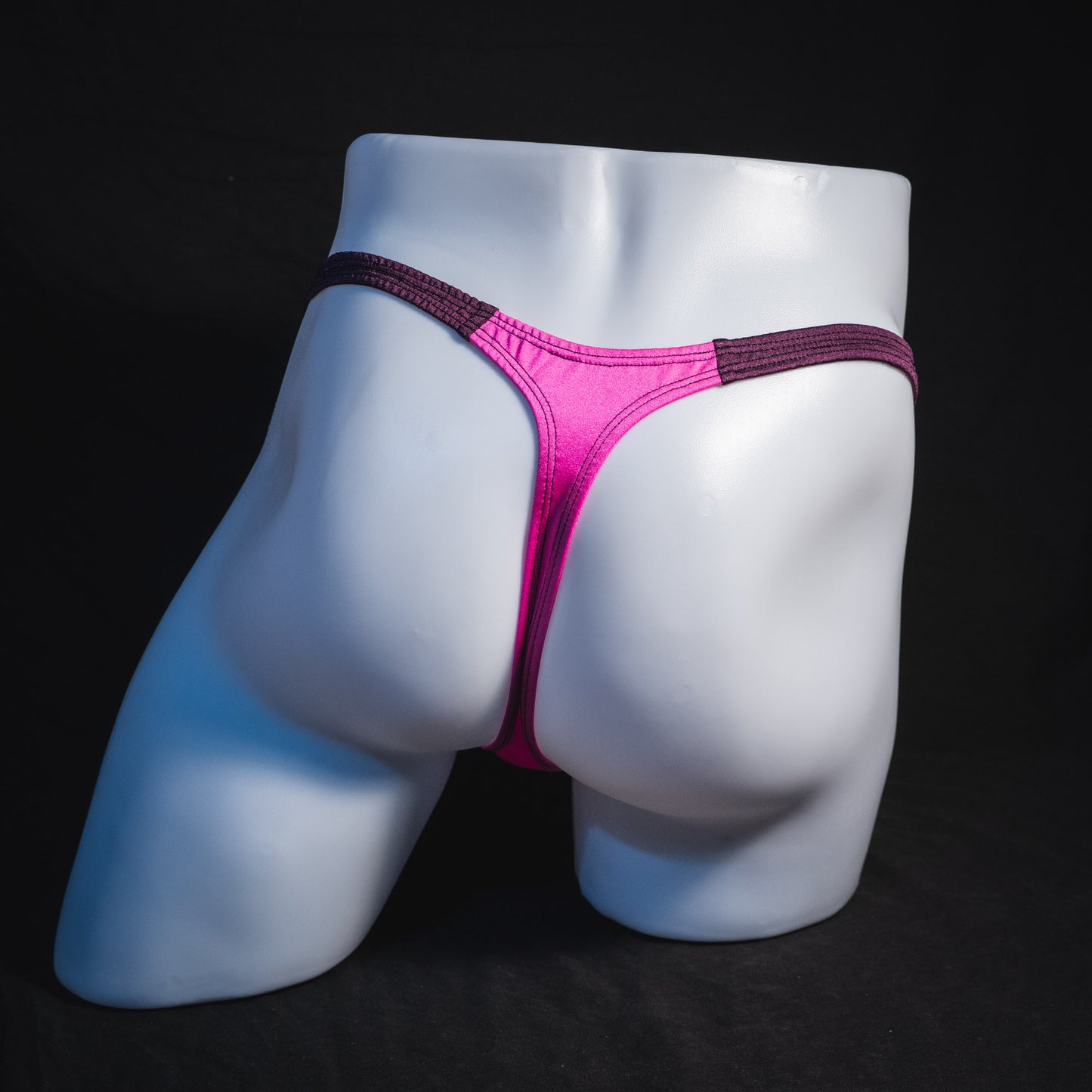 Men's pink and purple thong underwear, classic cut, full rear view.