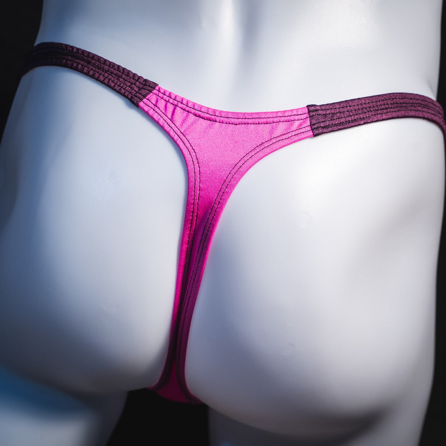 Men's pink and purple thong underwear, classic cut, rear view.