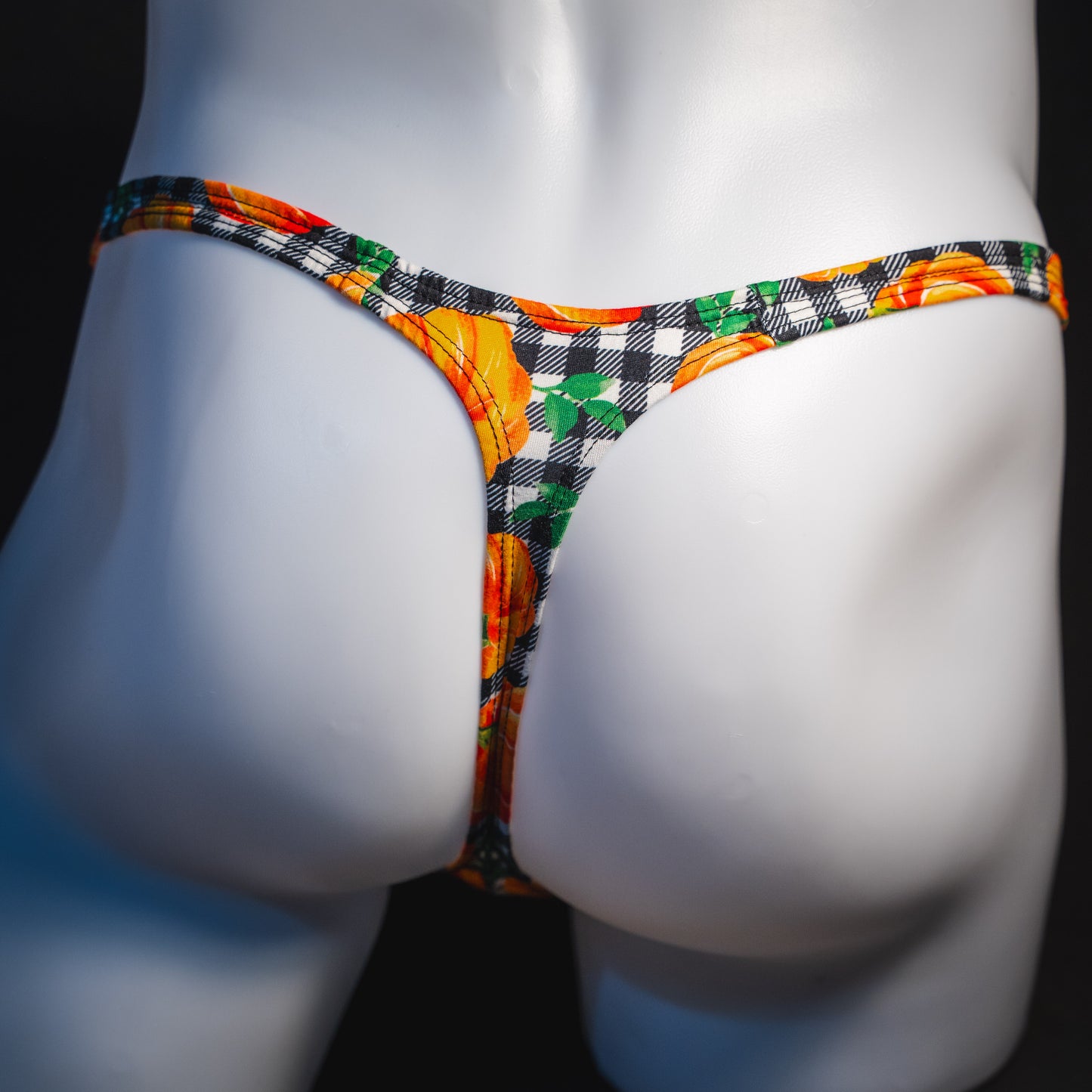 Men's pumpkin and plaid thong underwear, classic cut, rear view.