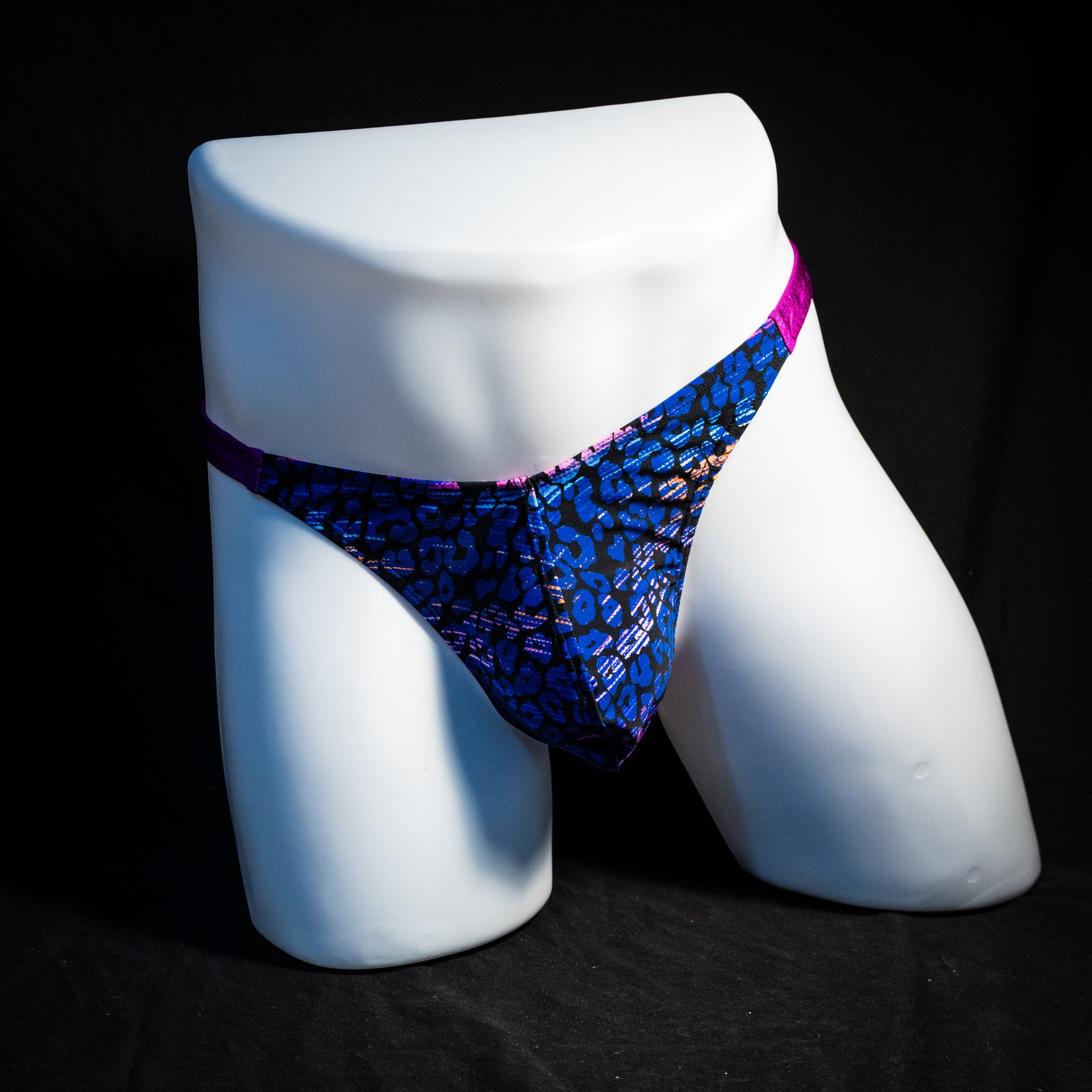 Men's purple and blue thong underwear, classic cut, full front view.