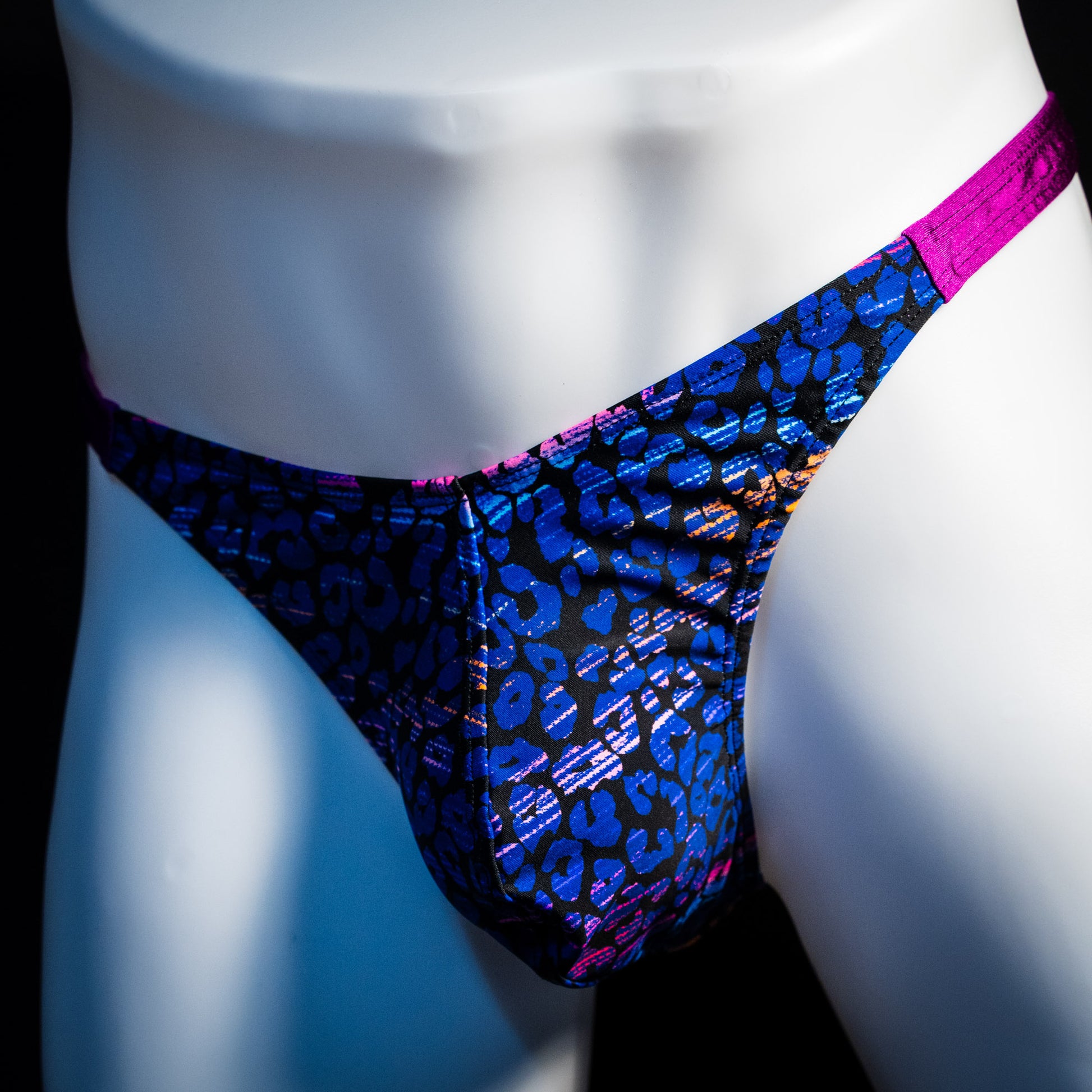 Men's purple and blue thong underwear, classic cut, front angled view.
