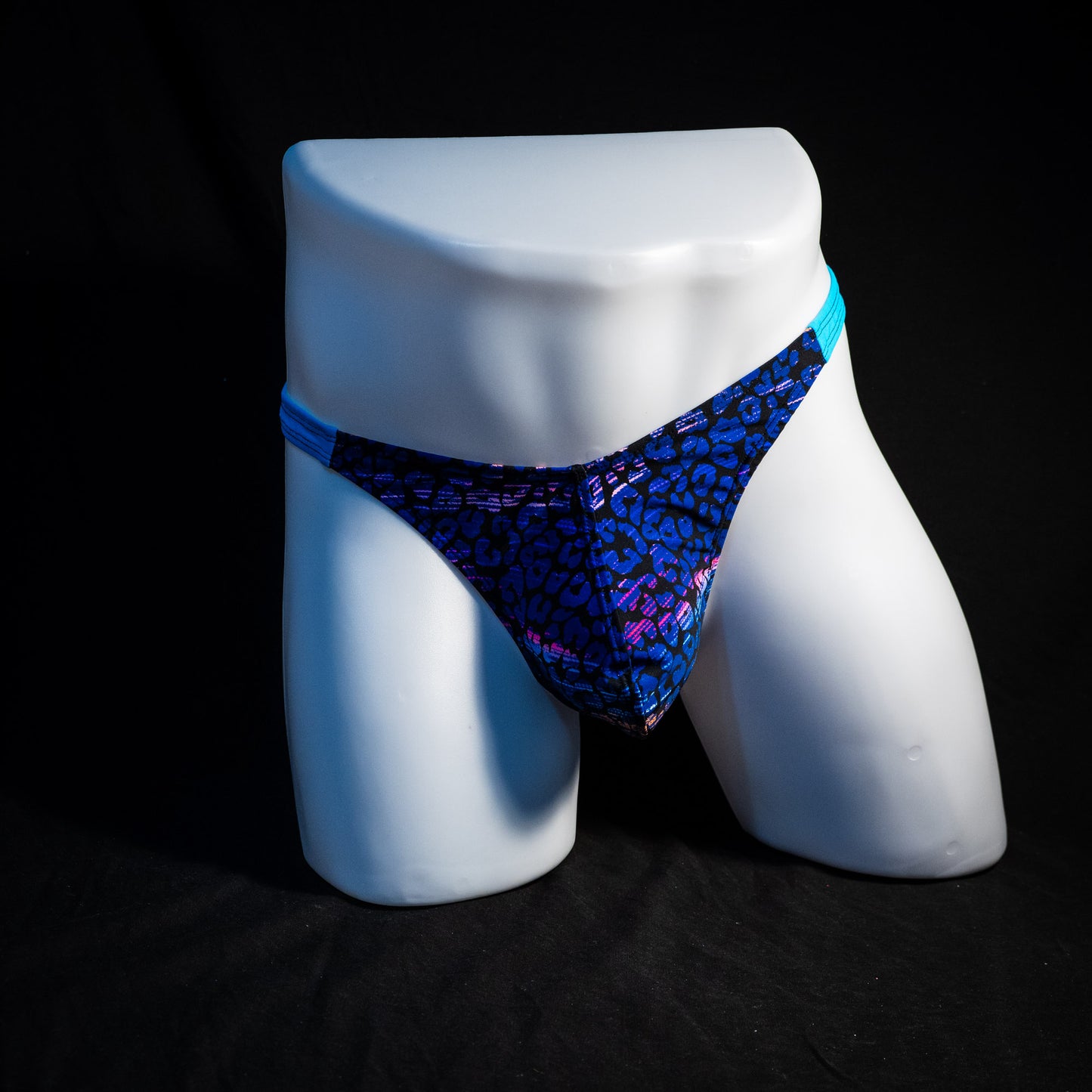 Men's purple and blue cheetah thong underwear, classic cut, full front view.