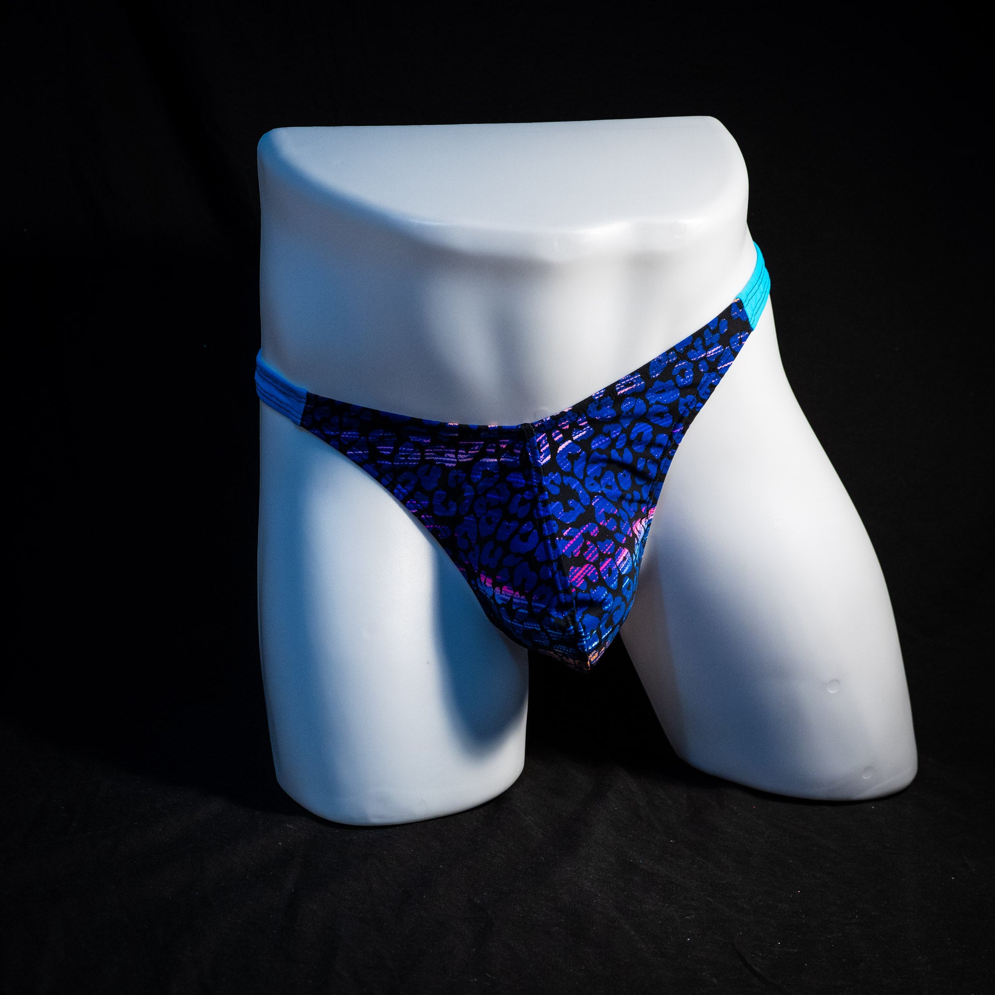 Men's purple and blue cheetah thong underwear, classic cut, full front view.