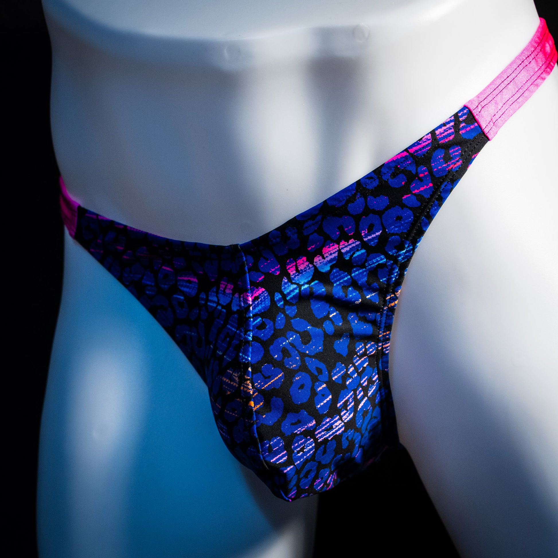 Men's purple and blue cheetah thong underwear, classic cut, front angled view.