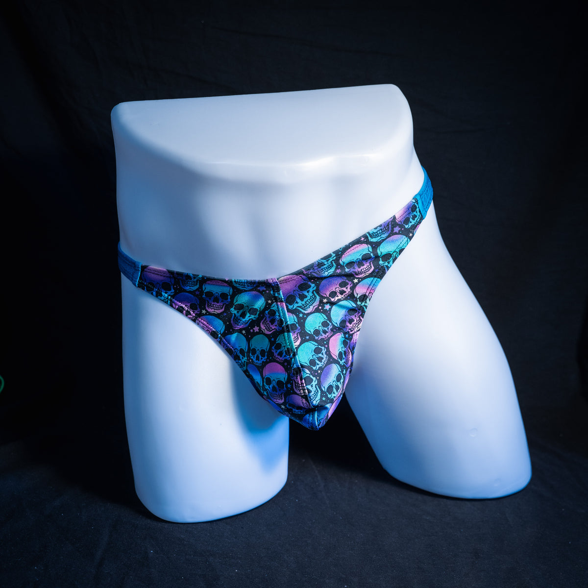 Men's purple and blue skulls thong underwear, classic cut, front view.