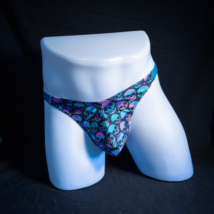 Men's purple and blue skulls thong underwear, classic cut, front view.