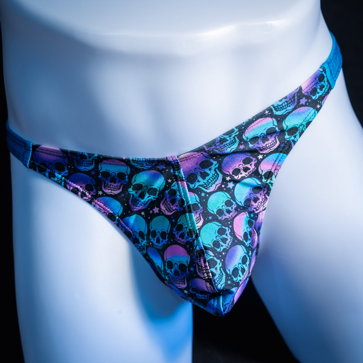 Men's purple and blue skulls thong underwear, classic cut, front view.