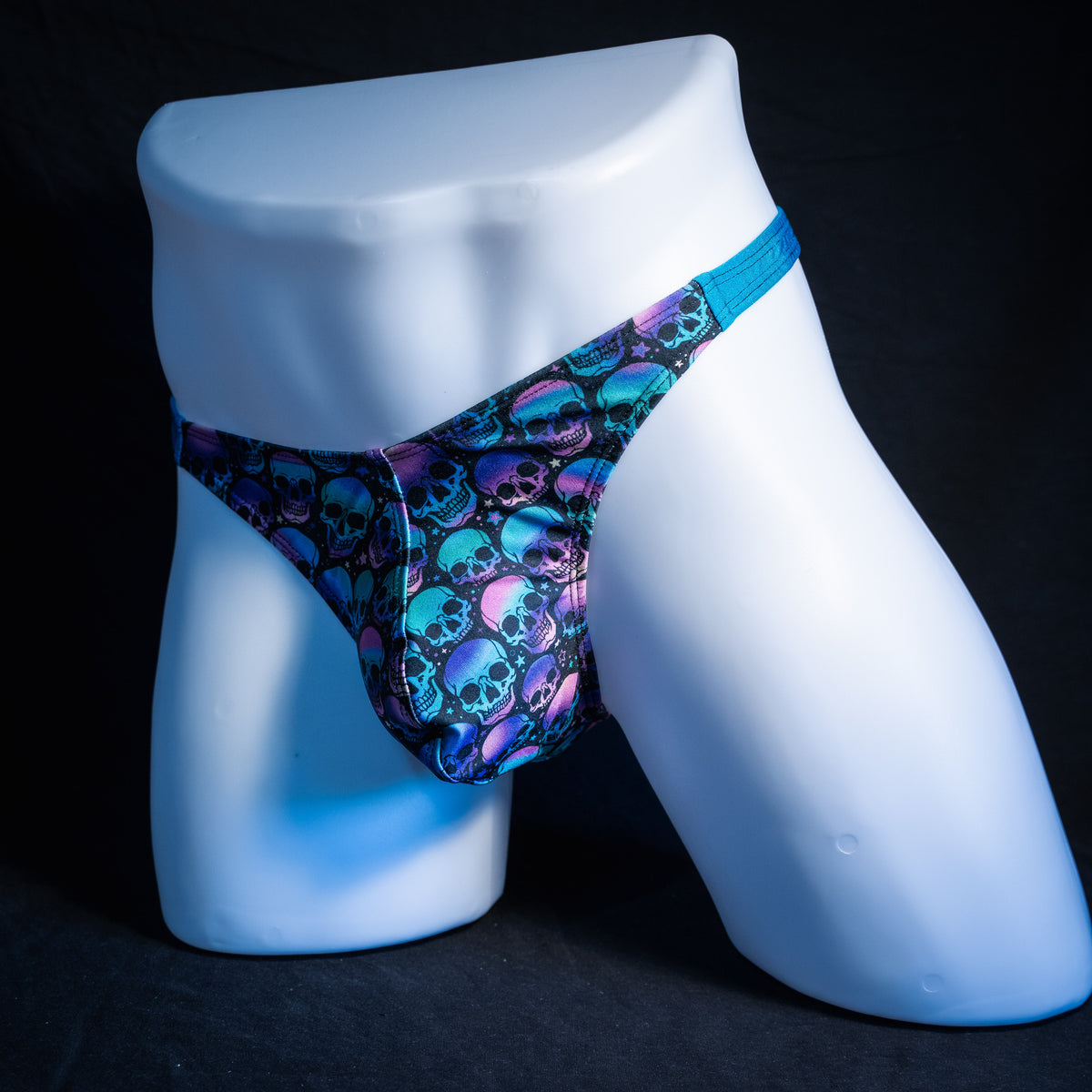 Men's purple and blue skulls thong underwear, classic cut, front view.