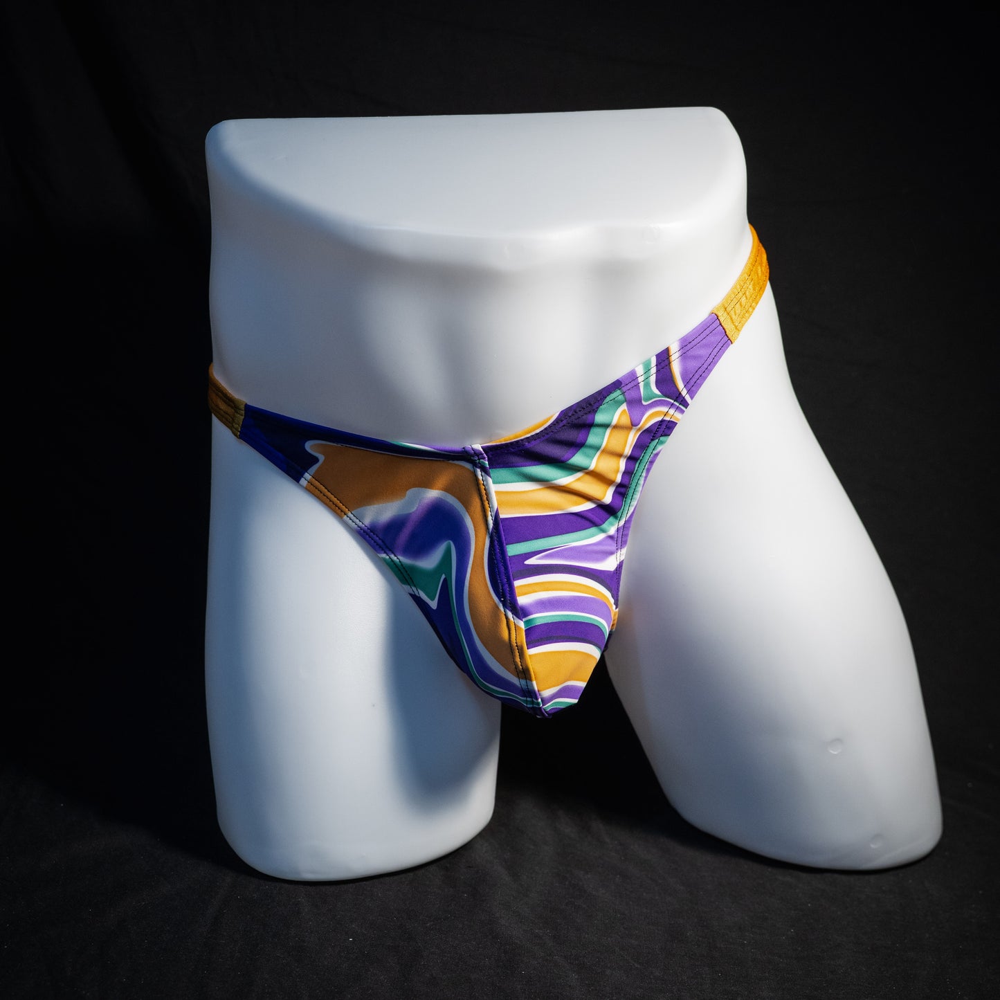 Men's purple and copper psychedelic thong underwear, classic cut, front view.