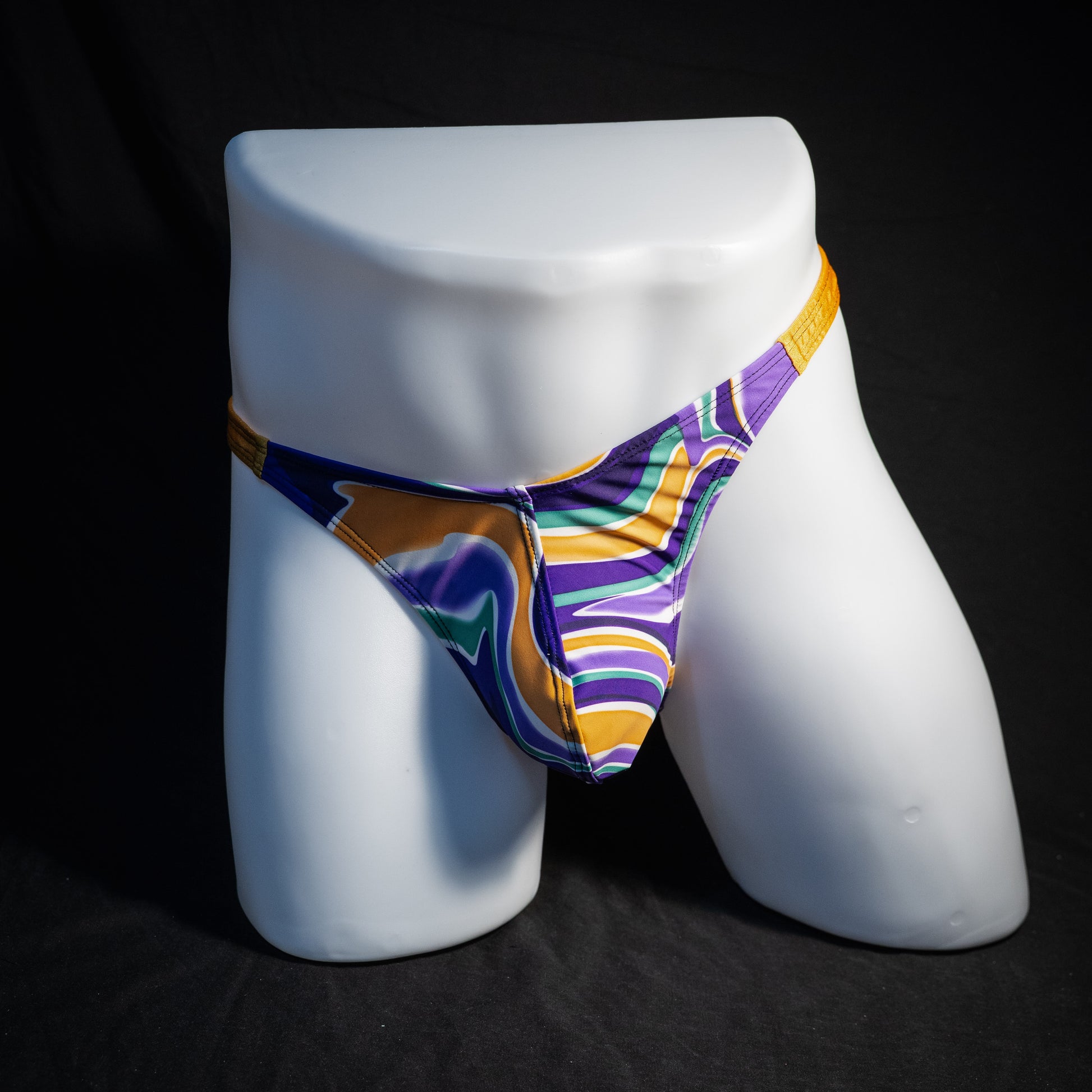 Men's purple and copper psychedelic thong underwear, classic cut, front view.