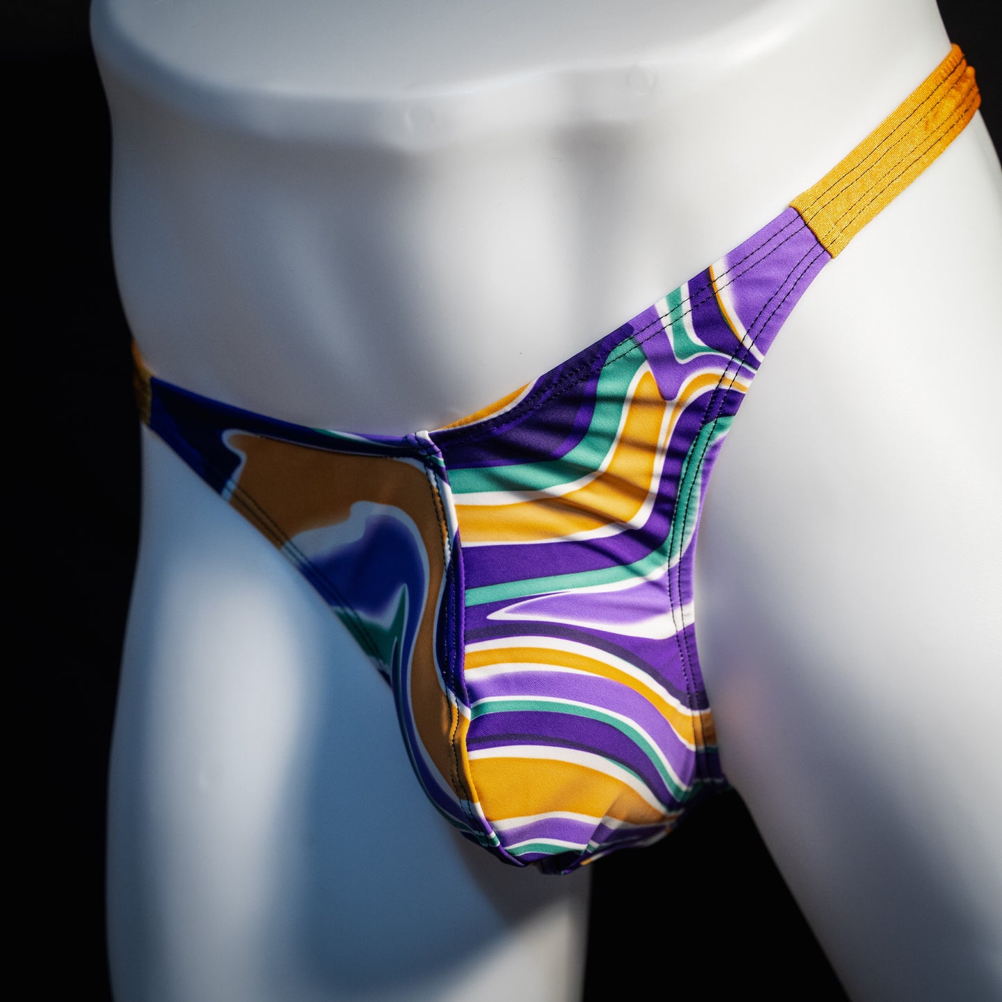 Men's purple and copper psychedelic thong underwear, classic cut, front view.
