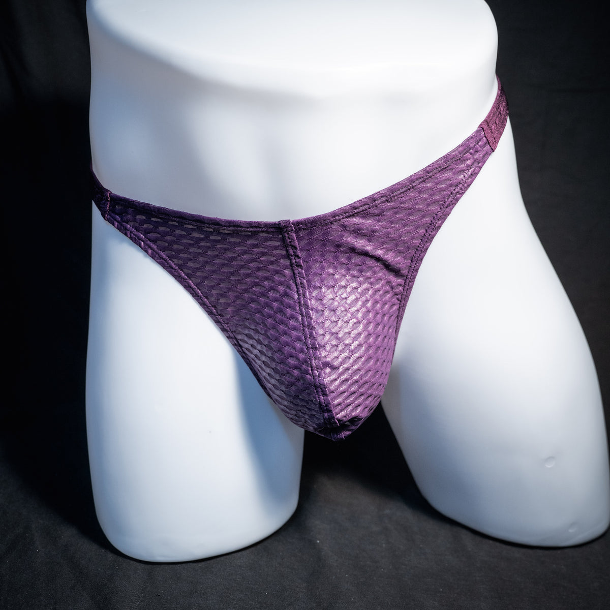 Men's purple athletic mesh thong underwear, classic cut, front view.