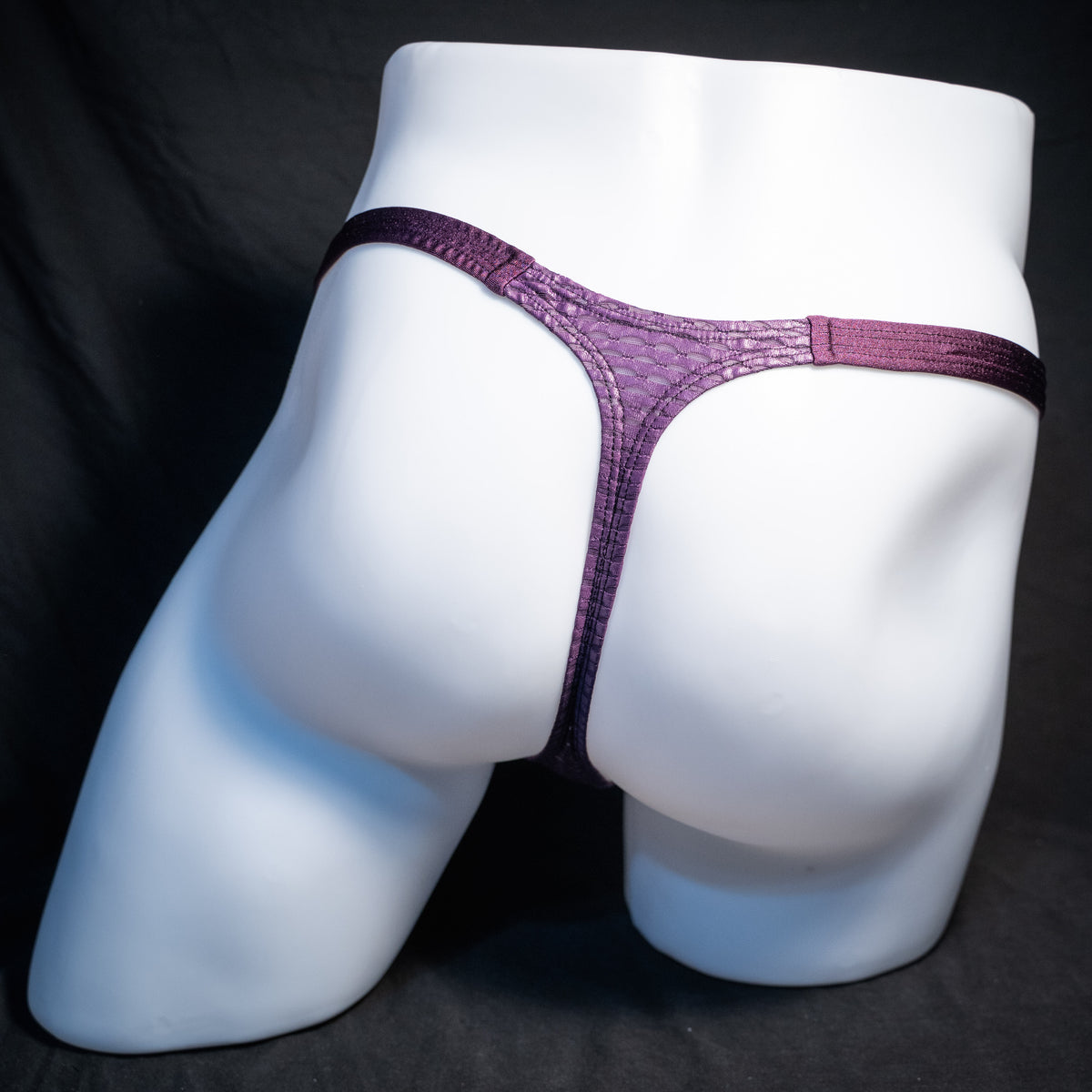Men's purple athletic mesh thong underwear, classic cut, rear view.