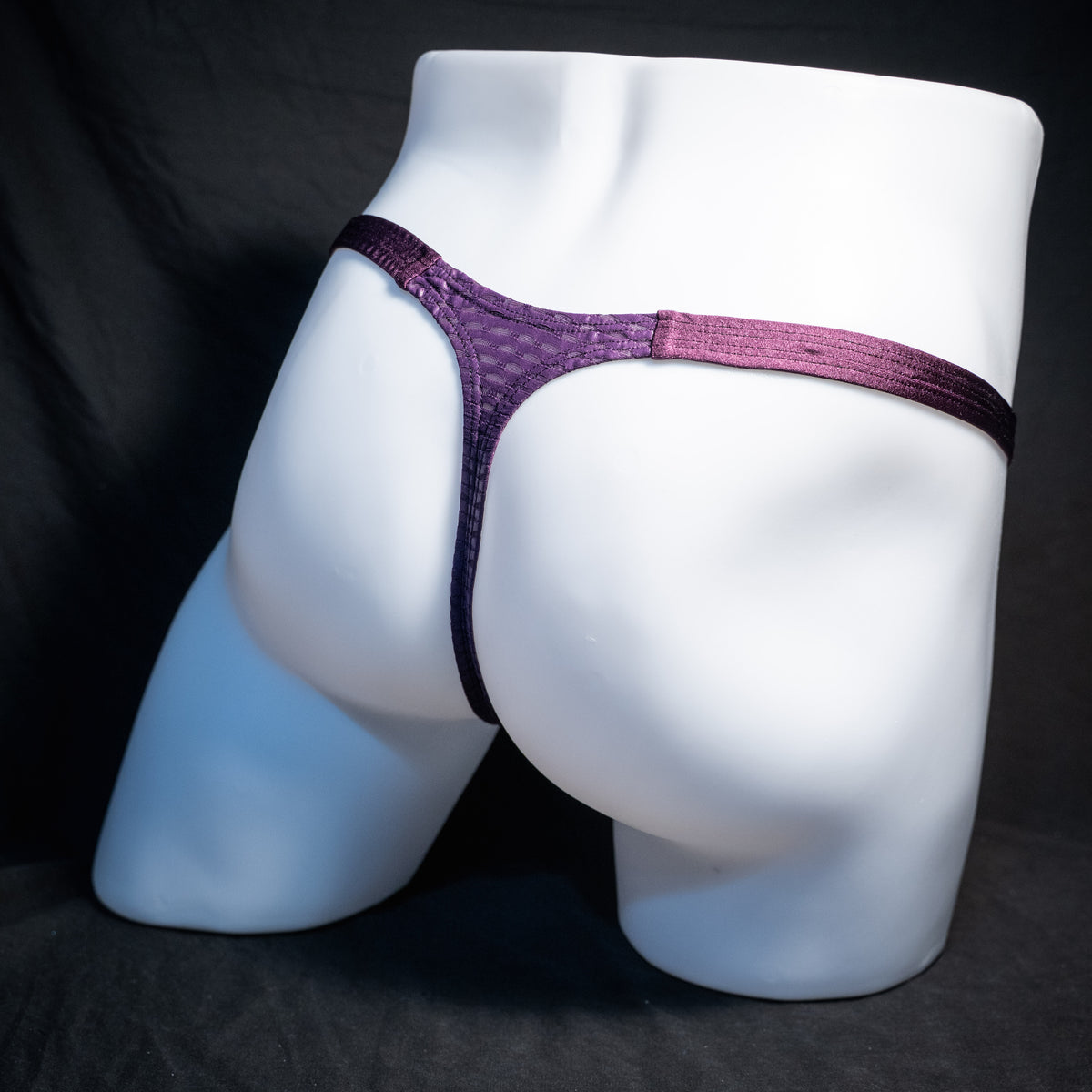 Men's purple athletic mesh thong underwear, classic cut, rear view.