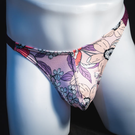Men's purple floral thong underwear, classic cut, front view.