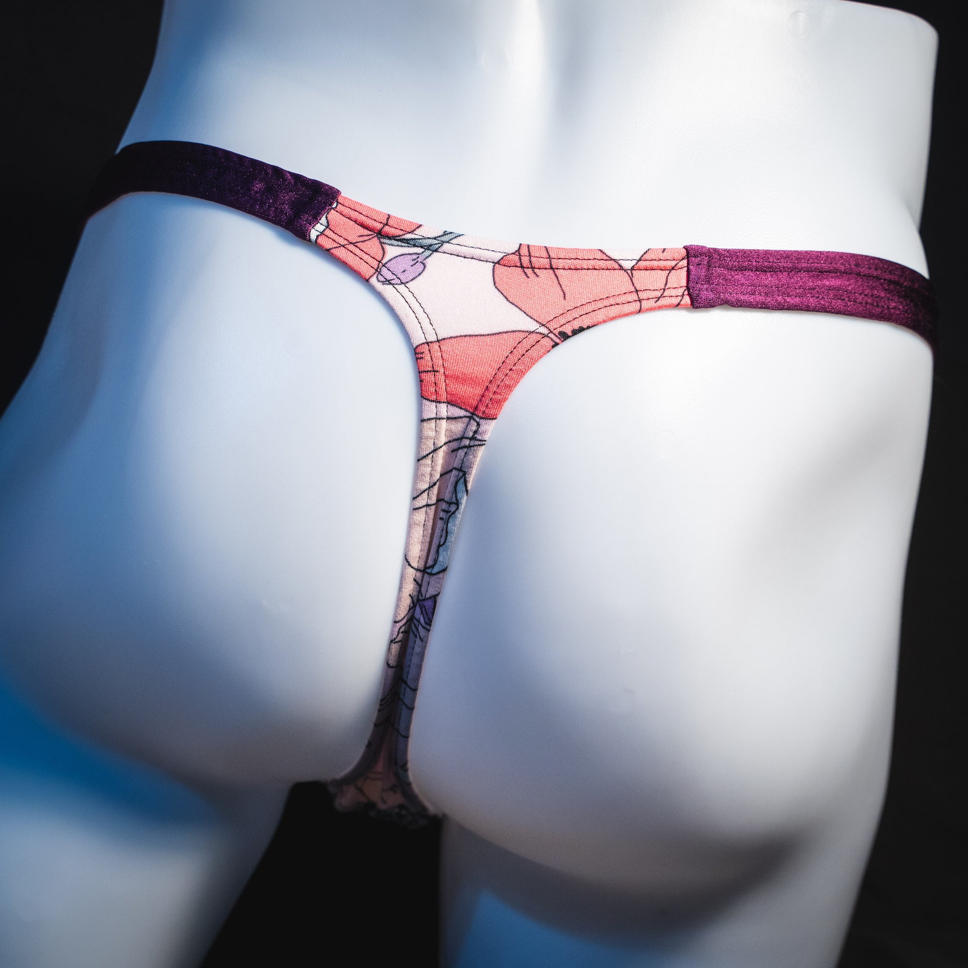 Men's purple floral thong underwear, classic cut, rear view.