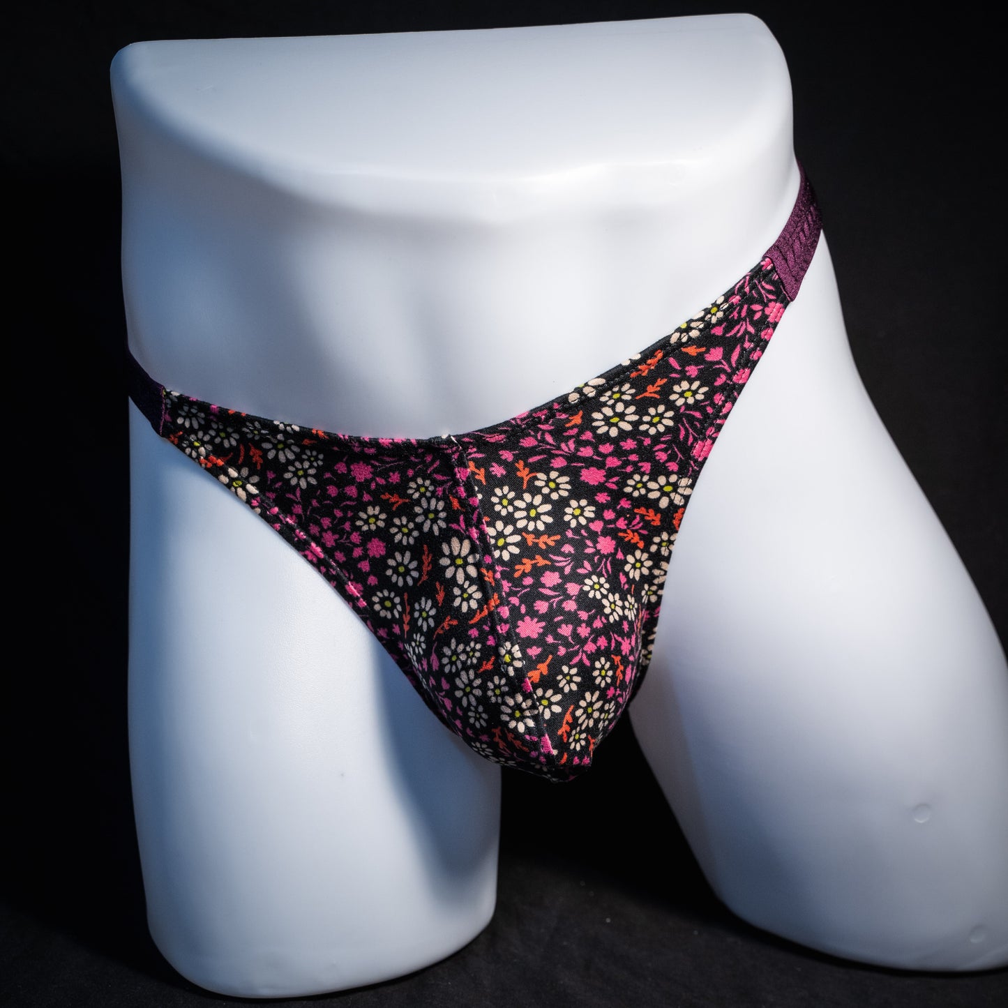 Men's purple floral thong underwear, classic cut, front view.