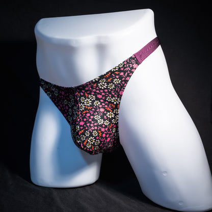 Men's purple floral thong underwear, classic cut, front view.
