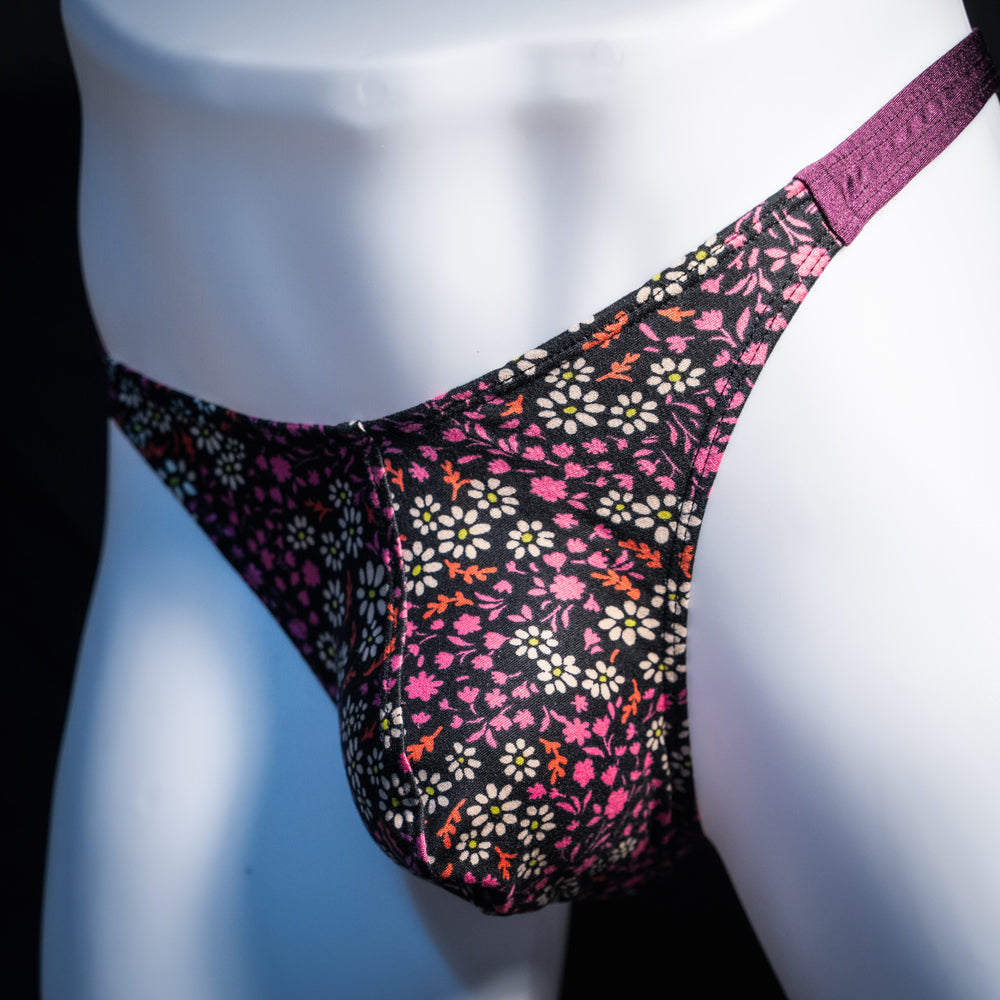 Men's purple floral thong underwear, classic cut, front view.