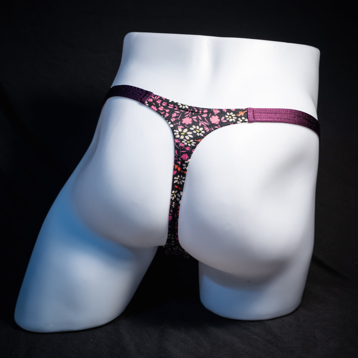 Men's purple floral thong underwear, classic cut, rear view.
