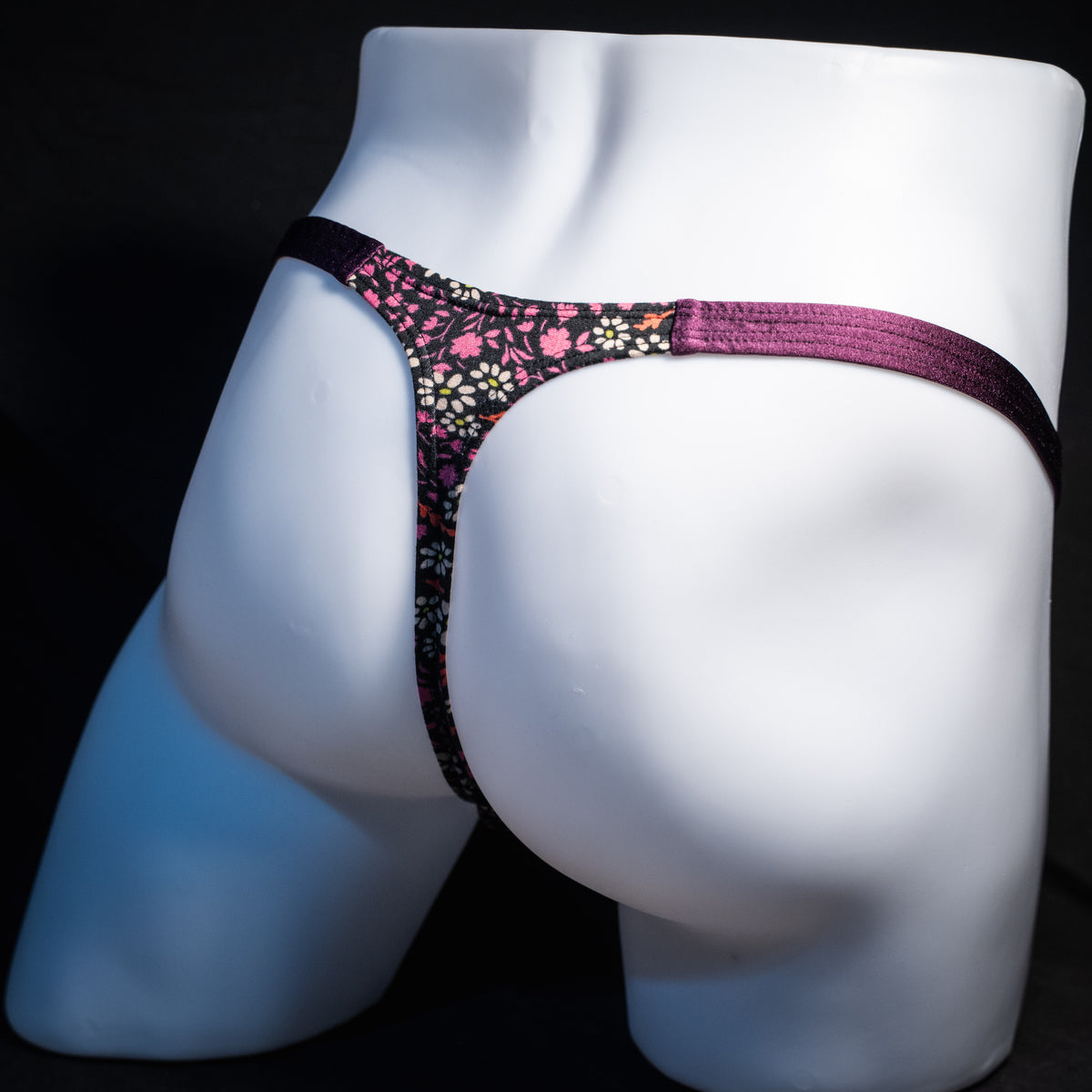 Men's purple floral thong underwear, classic cut, rear view.
