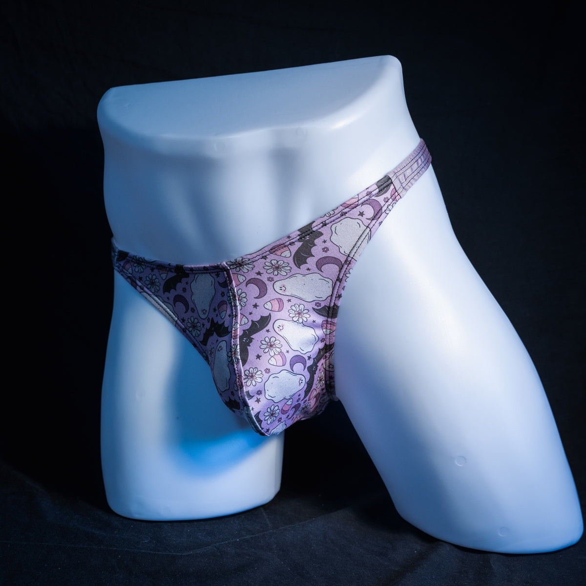 Men's purple ghosts and bats Halloween themed thong underwear, classic cut, front view.