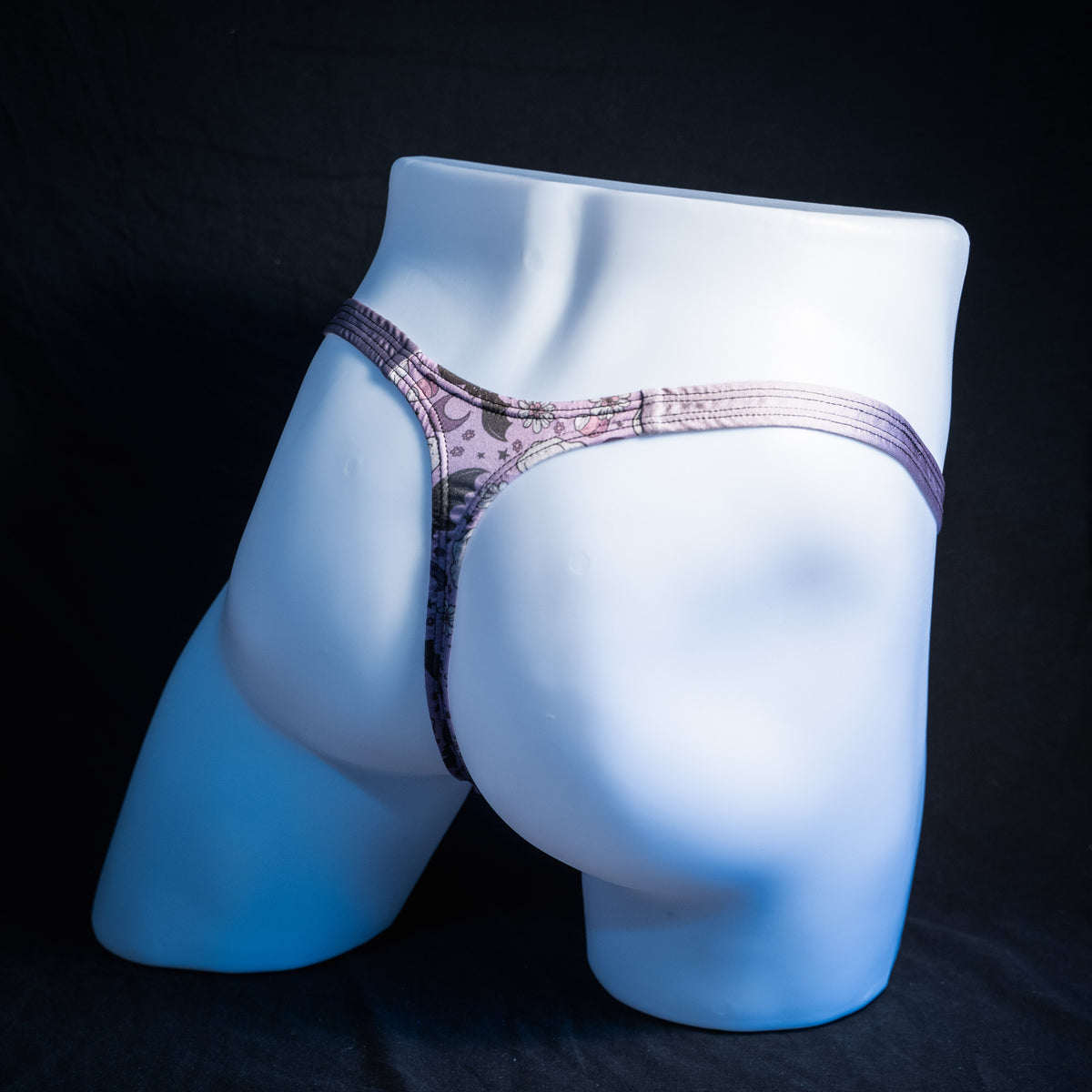 Men's purple ghosts and bats Halloween themed thong underwear, classic cut, rear view.