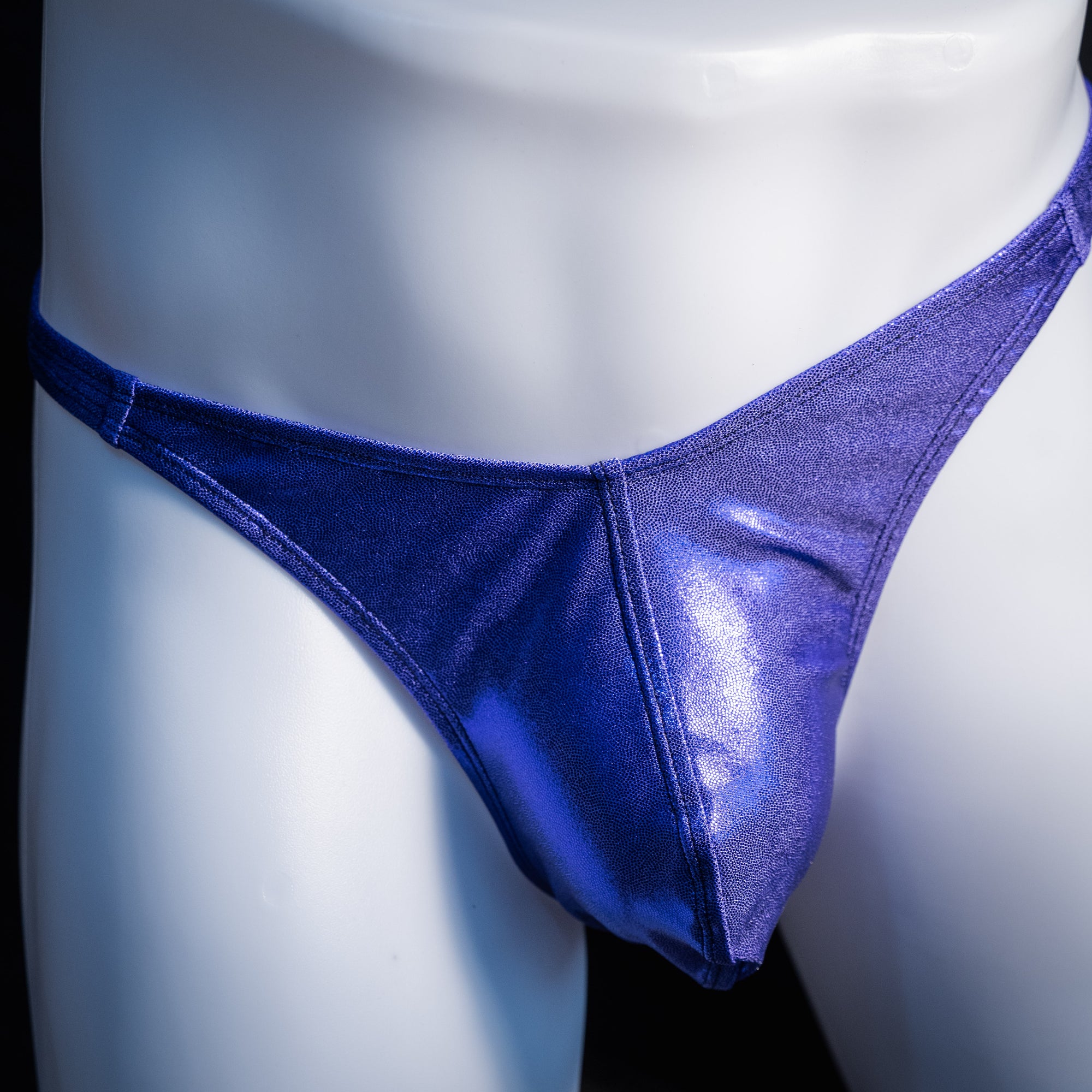 Men's purple metallic thong underwear, classic cut, front view.