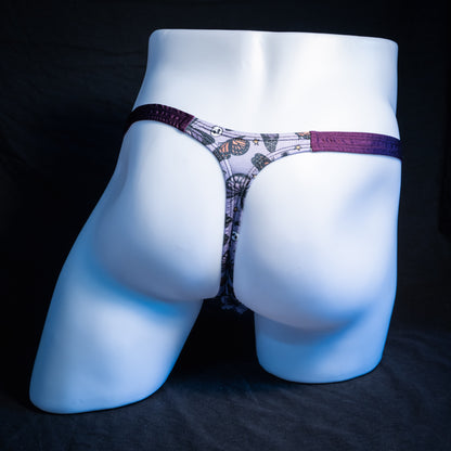 Men's purple skulls and butterflies thong underwear, classic cut, rear view.