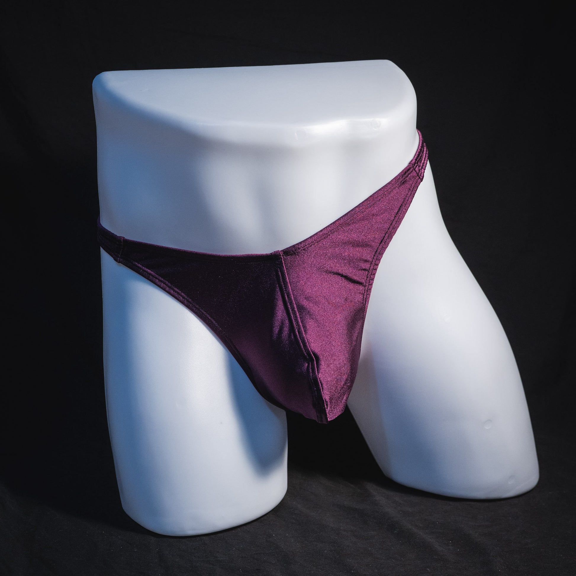 Men's solid purple thong underwear, classic cut, full front view.