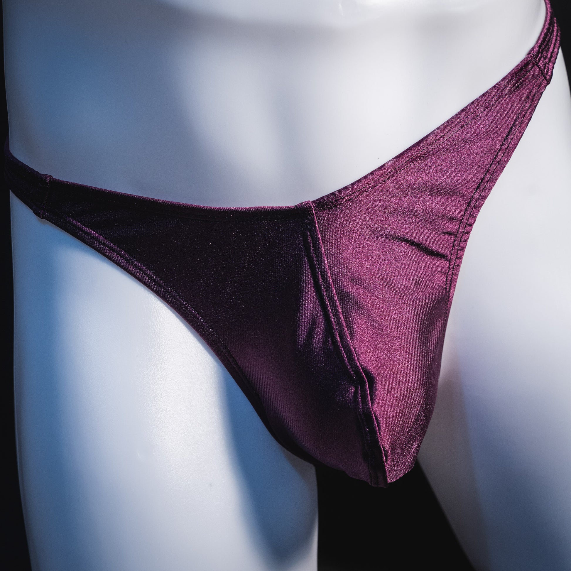 Men's solid purple thong underwear, classic cut, front view.
