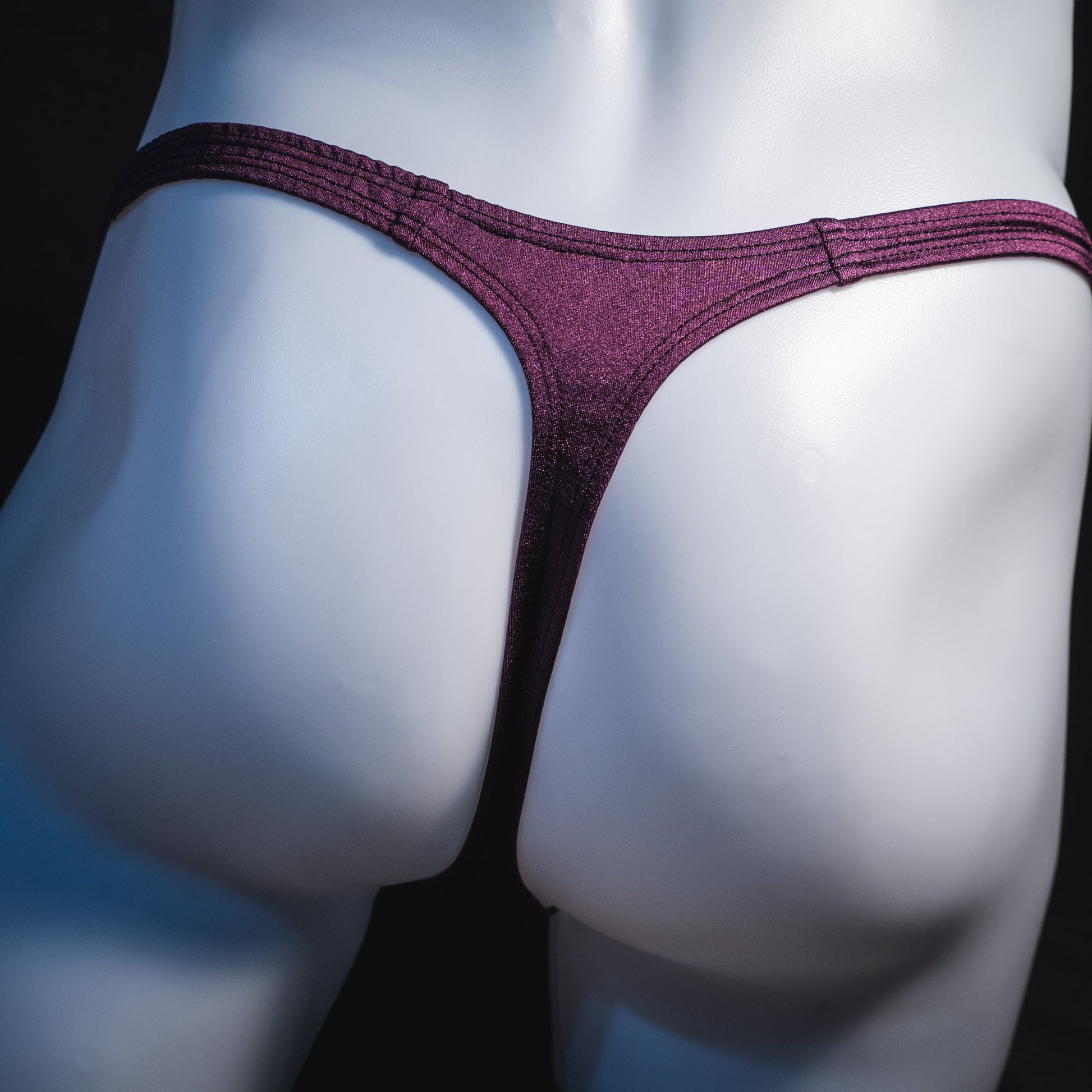 Men's solid purple thong underwear, classic cut, rear view.