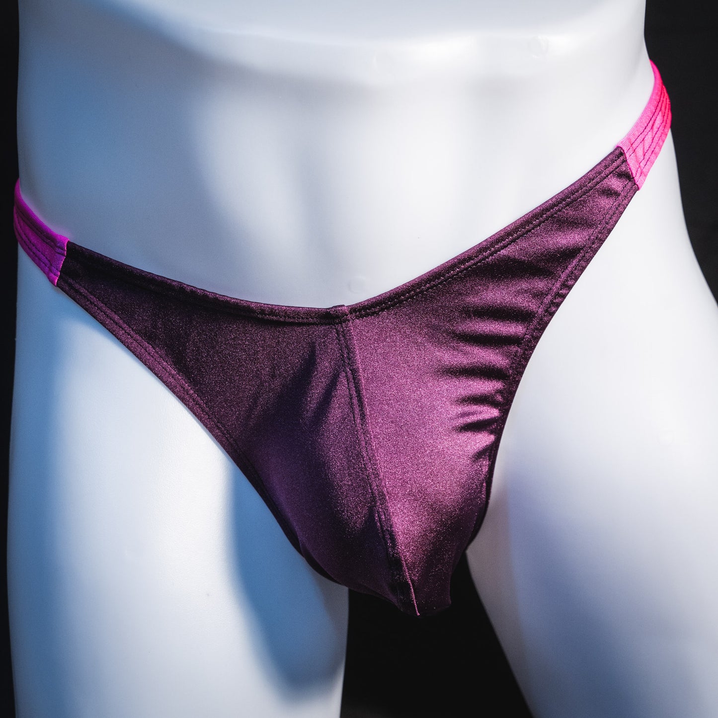 Men's purple and pink thong underwear, classic cut, front view.