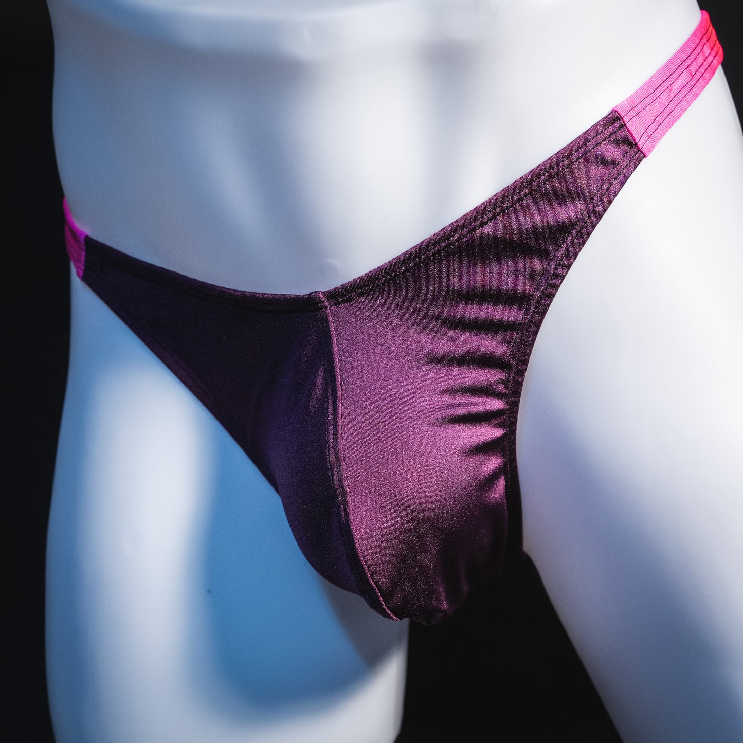 Men's purple and pink thong underwear, classic cut, front angled view.