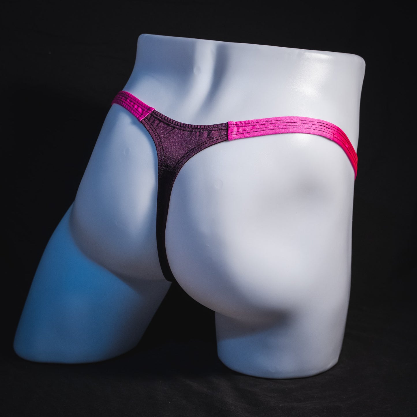 Men's purple and pink thong underwear, classic cut, full angled rear view.