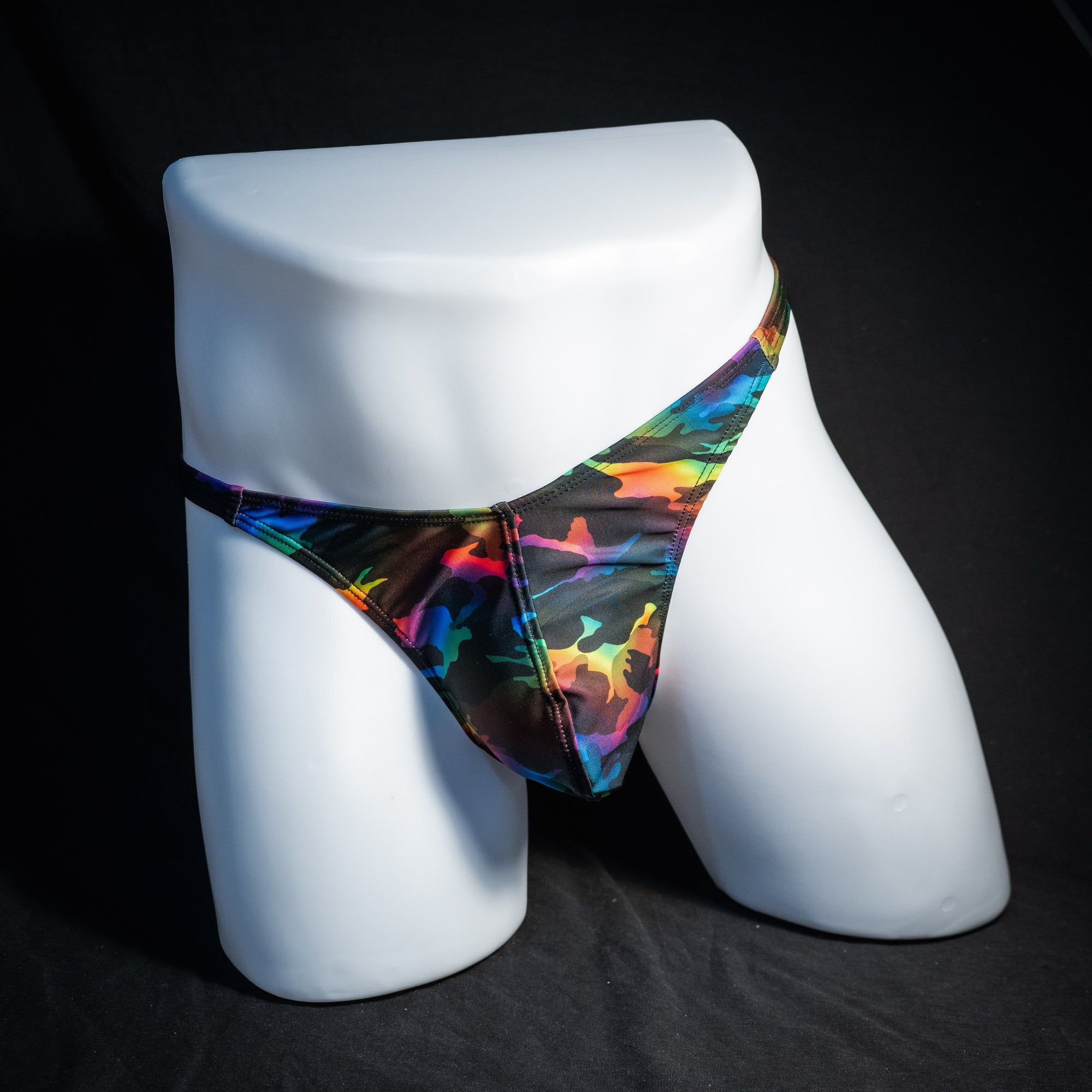 Men's rainbow camo thong underwear, classic cut, front view.
