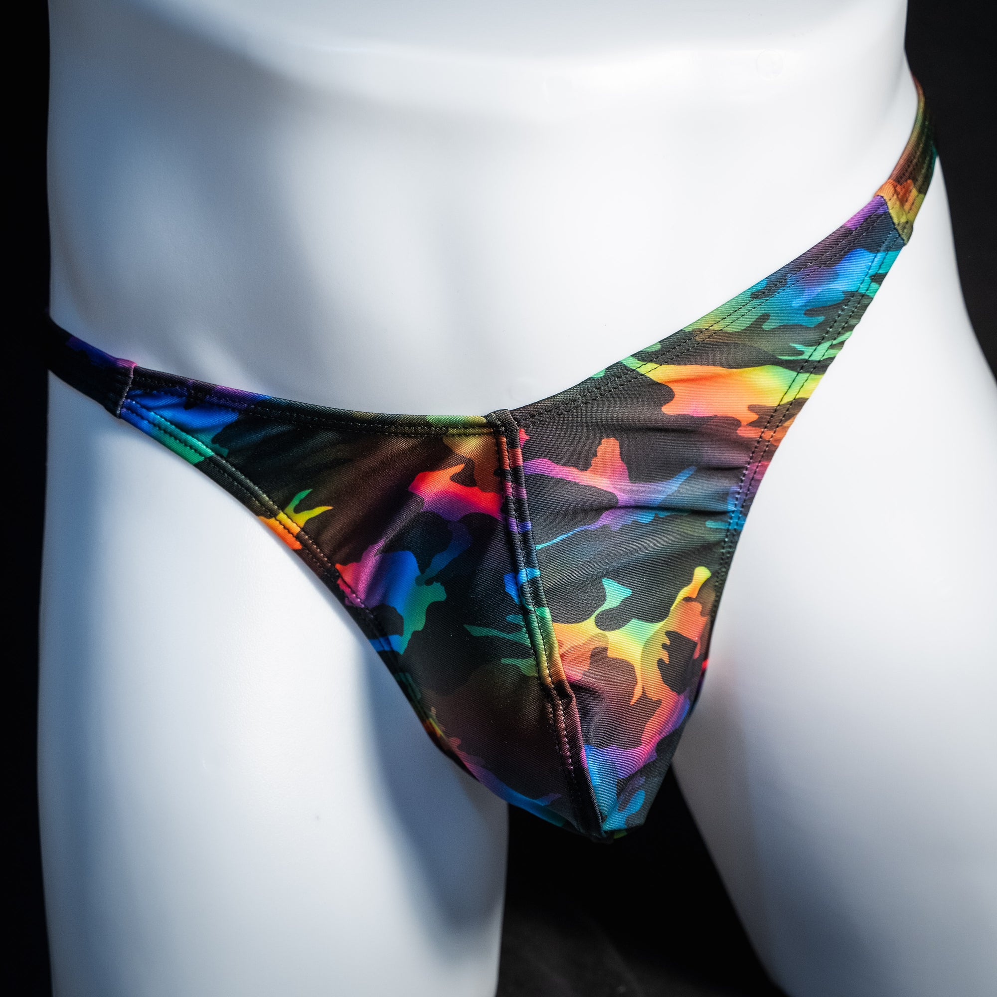 Men's rainbow camo thong underwear, classic cut, front view.